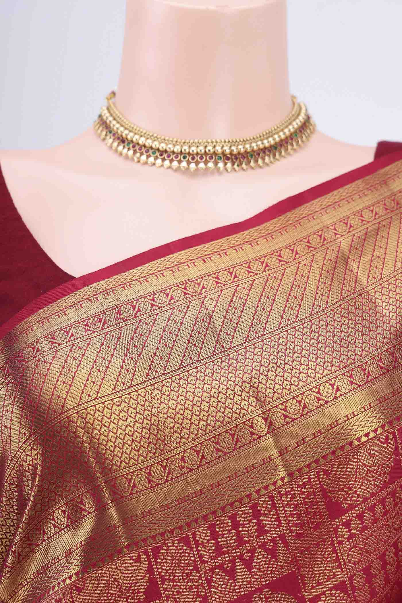 Border image of Maroon Kanchipuram Saree with Zari Brocade on the body and Rising Temple Border. 