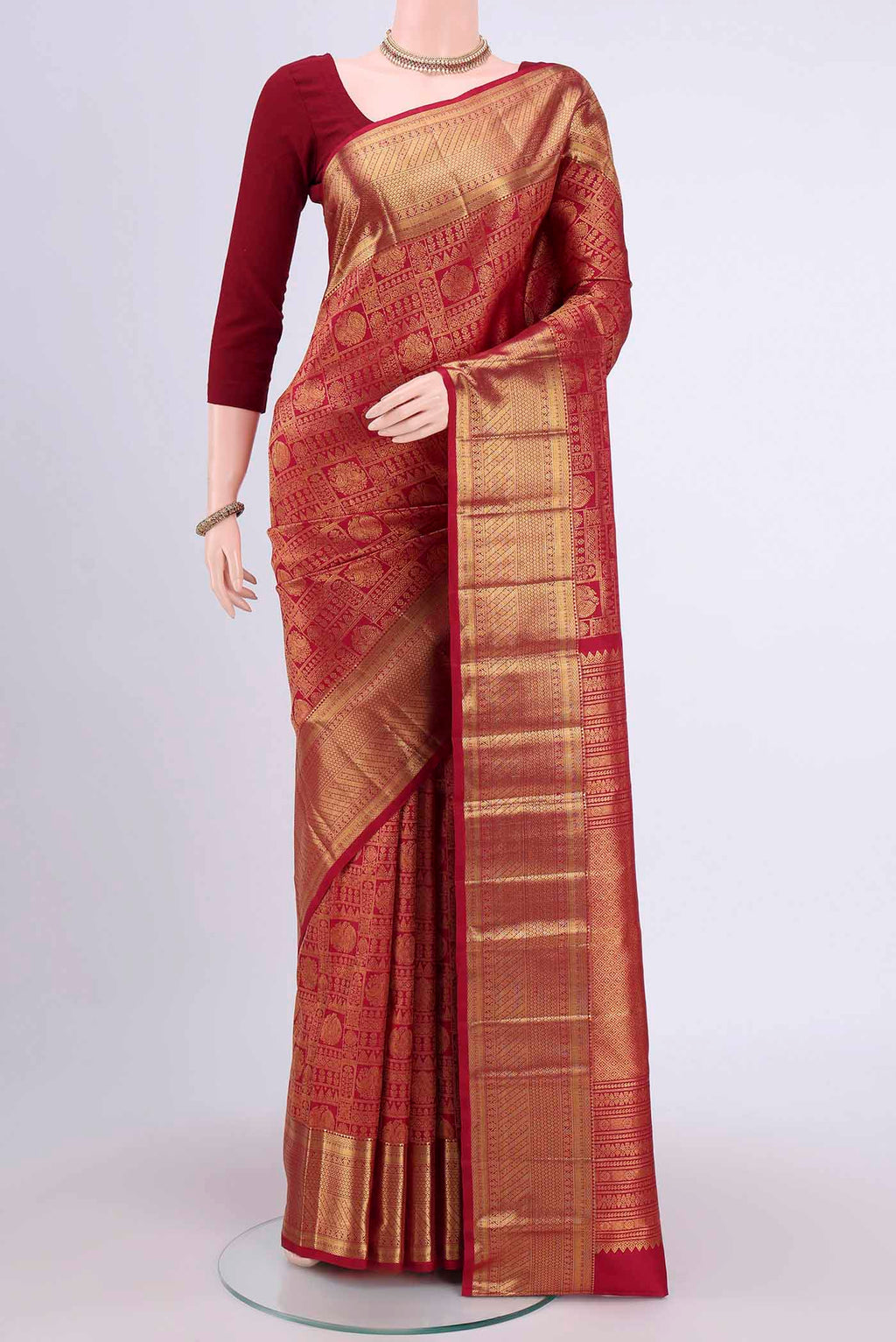 Maroon Kanchipuram Saree with Zari Brocade on the body and Rising Temple Border.  displayed on a mannequin