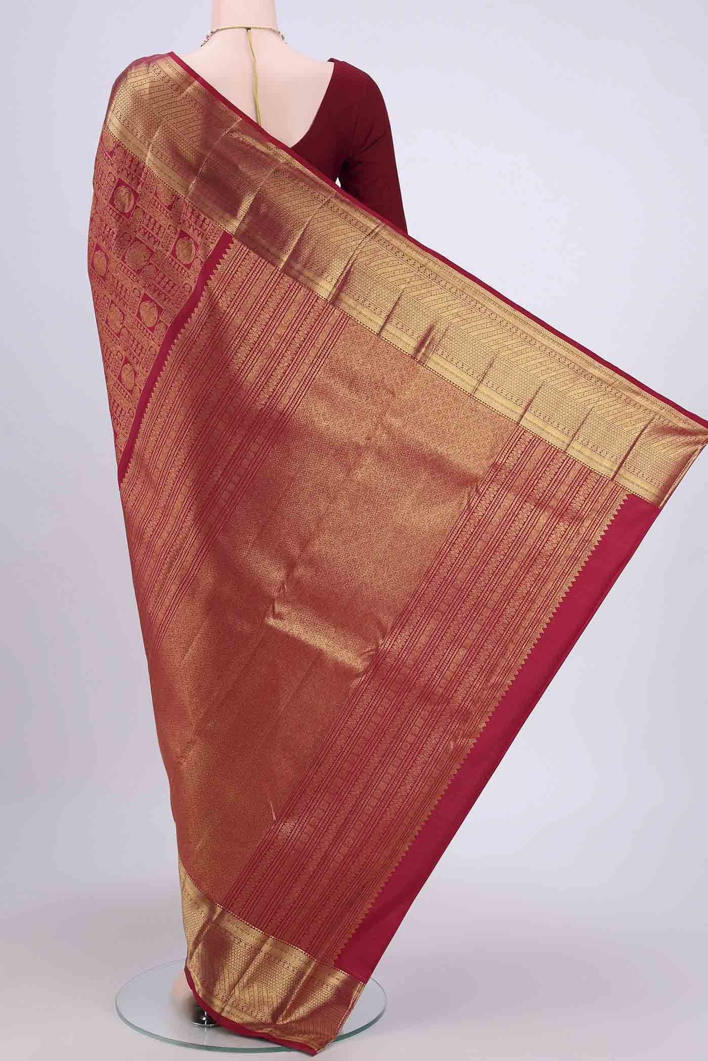 Flat view of Maroon Kanchipuram Saree with Zari Brocade on the body and Rising Temple Border. 