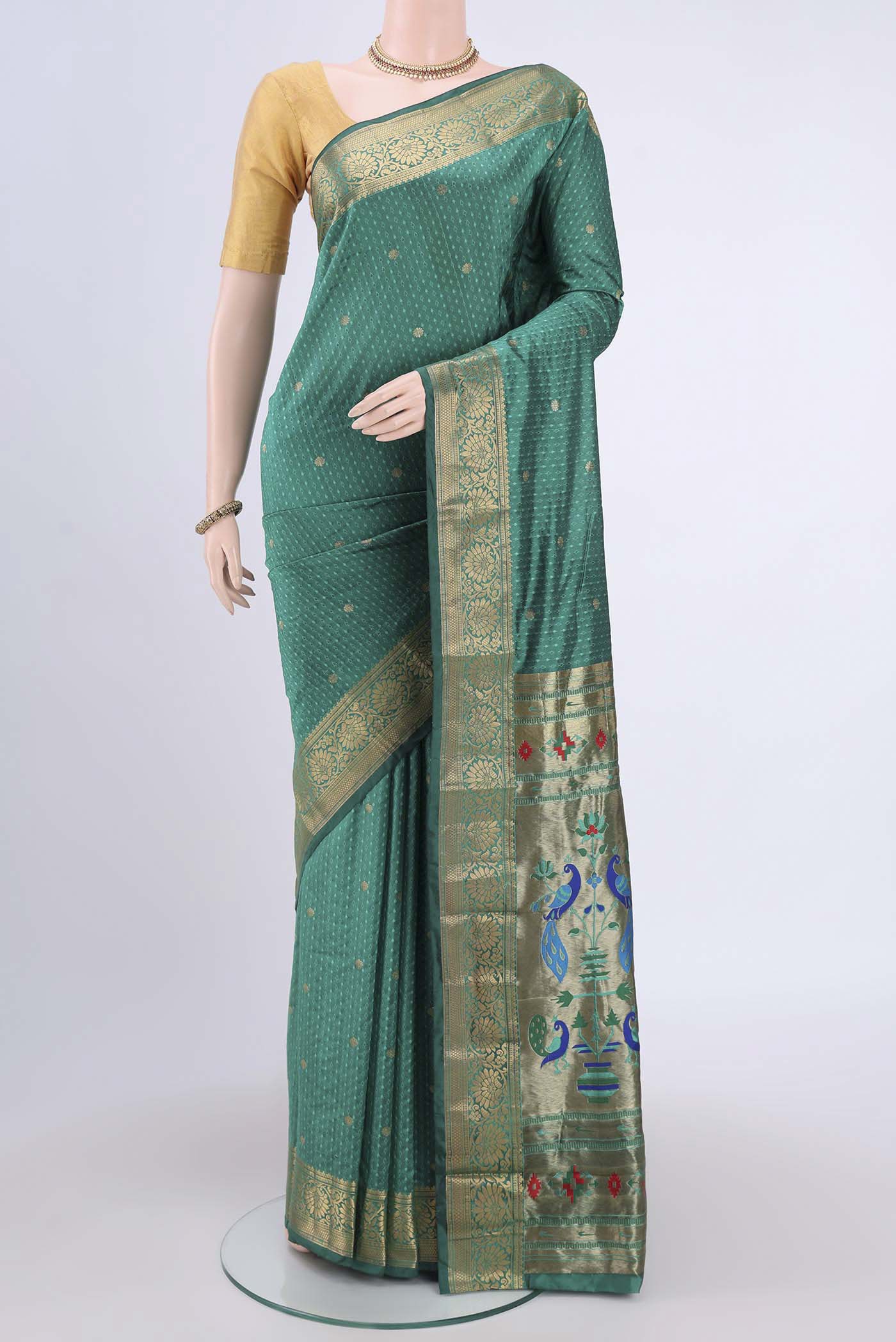 Sea Green Blended Bangalore Silk Saree with Jacquard With Zari Butta on the body and Zari Border.  displayed on a mannequin