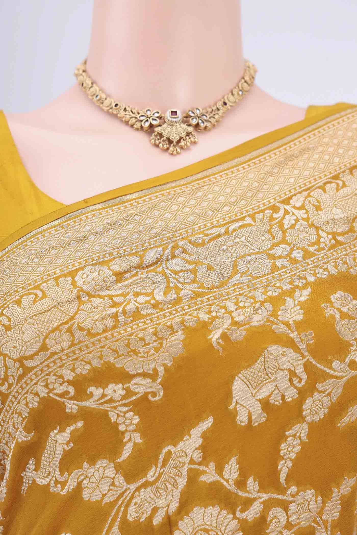 Border image of Mustard Banarasi Georgette Saree with Zari Brocade on the body and Zari Border. 