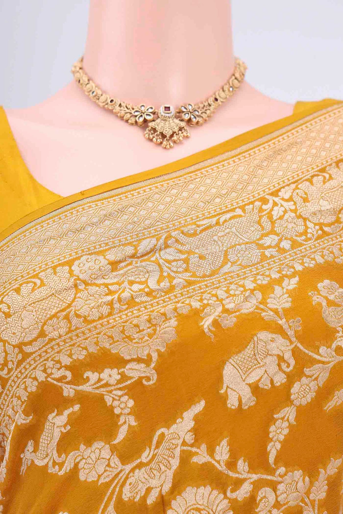 Border image of Mustard Banarasi Georgette Saree with Zari Brocade on the body and Zari Border. 
