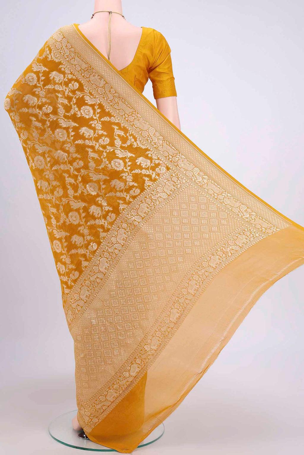 Flat view of Mustard Banarasi Georgette Saree with Zari Brocade on the body and Zari Border. 