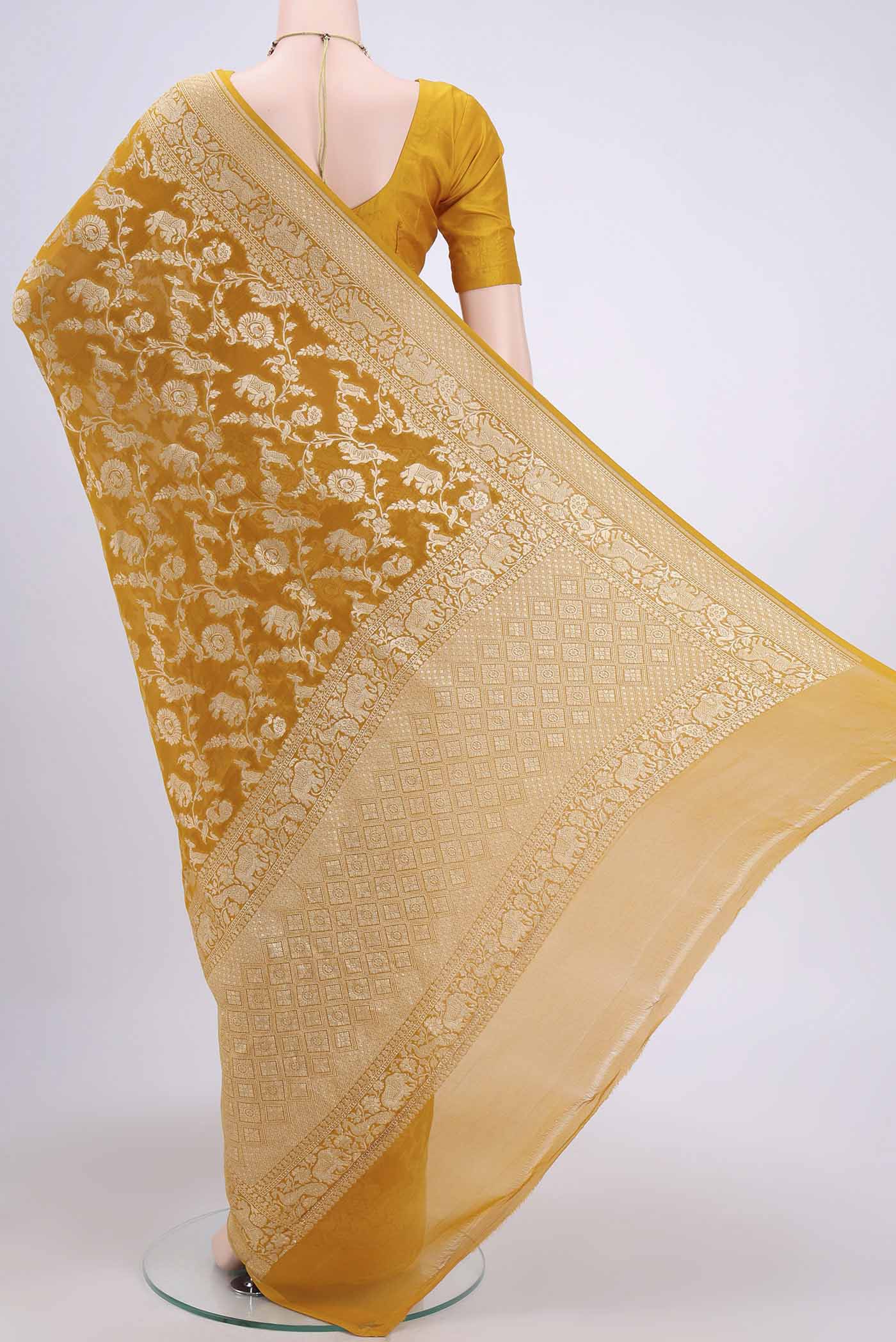 Flat view of Mustard Banarasi Georgette Saree with Zari Brocade on the body and Zari Border. 