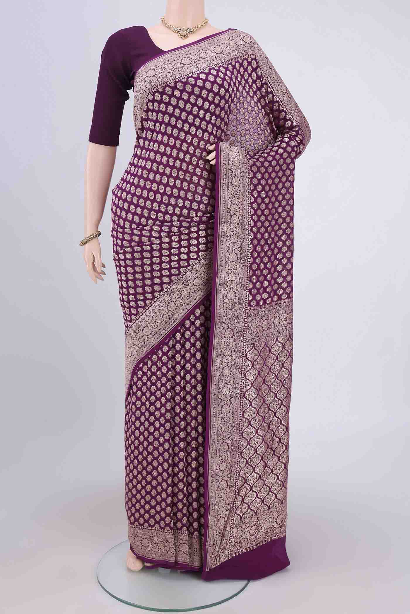 Magenta Banarasi Georgette Saree with Zari Brocade on the body and Zari Border.  displayed on a mannequin