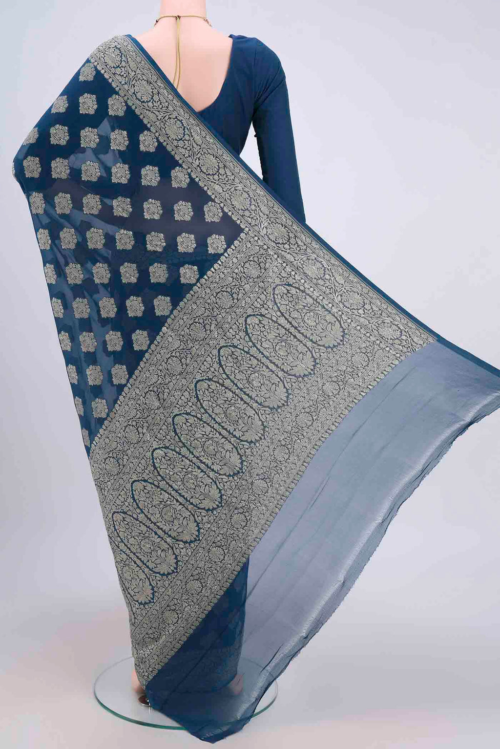 Flat view of Blue Banarasi Georgette Saree with Zari Brocade on the body and Zari Border. 