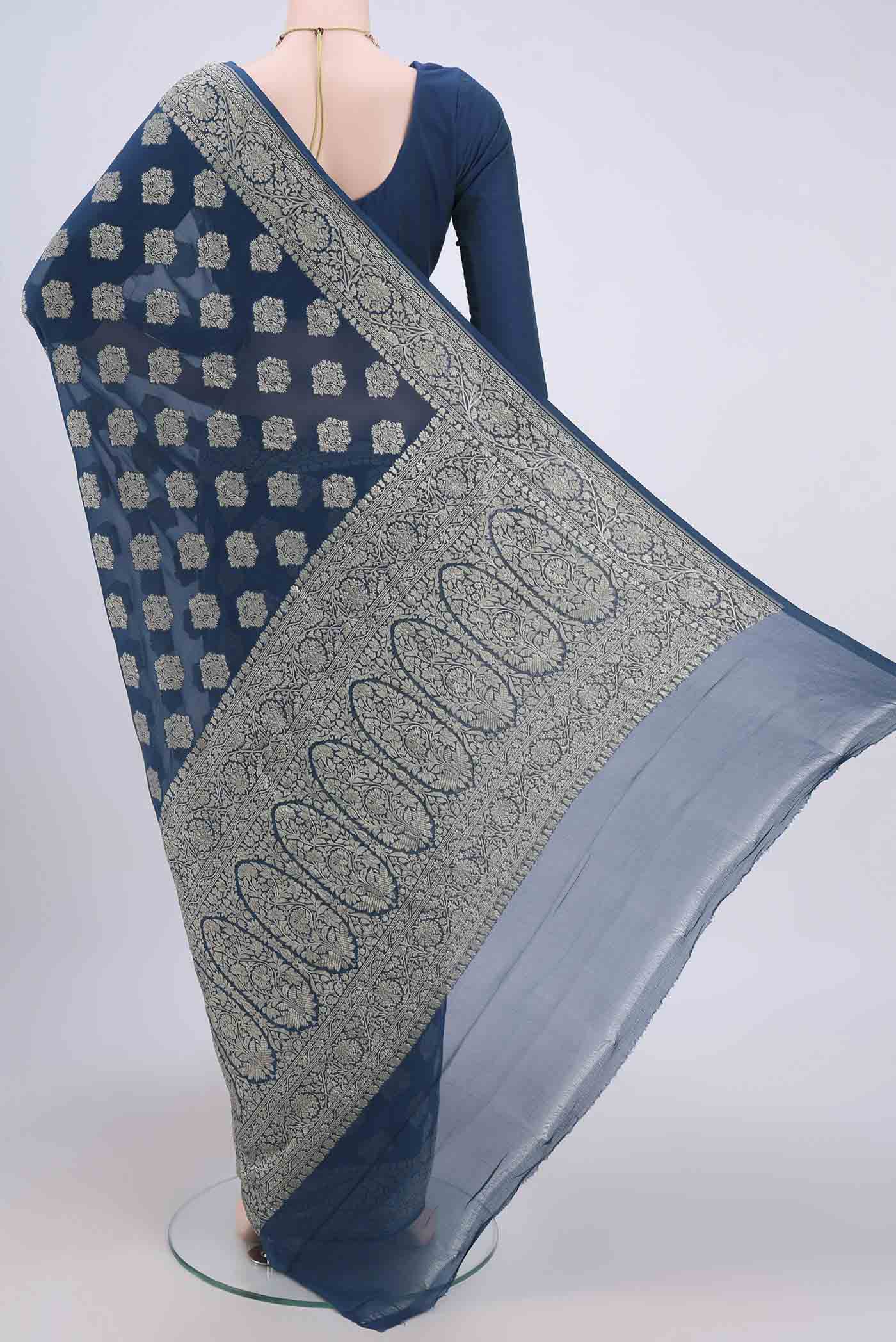 Flat view of Blue Banarasi Georgette Saree with Zari Brocade on the body and Zari Border. 