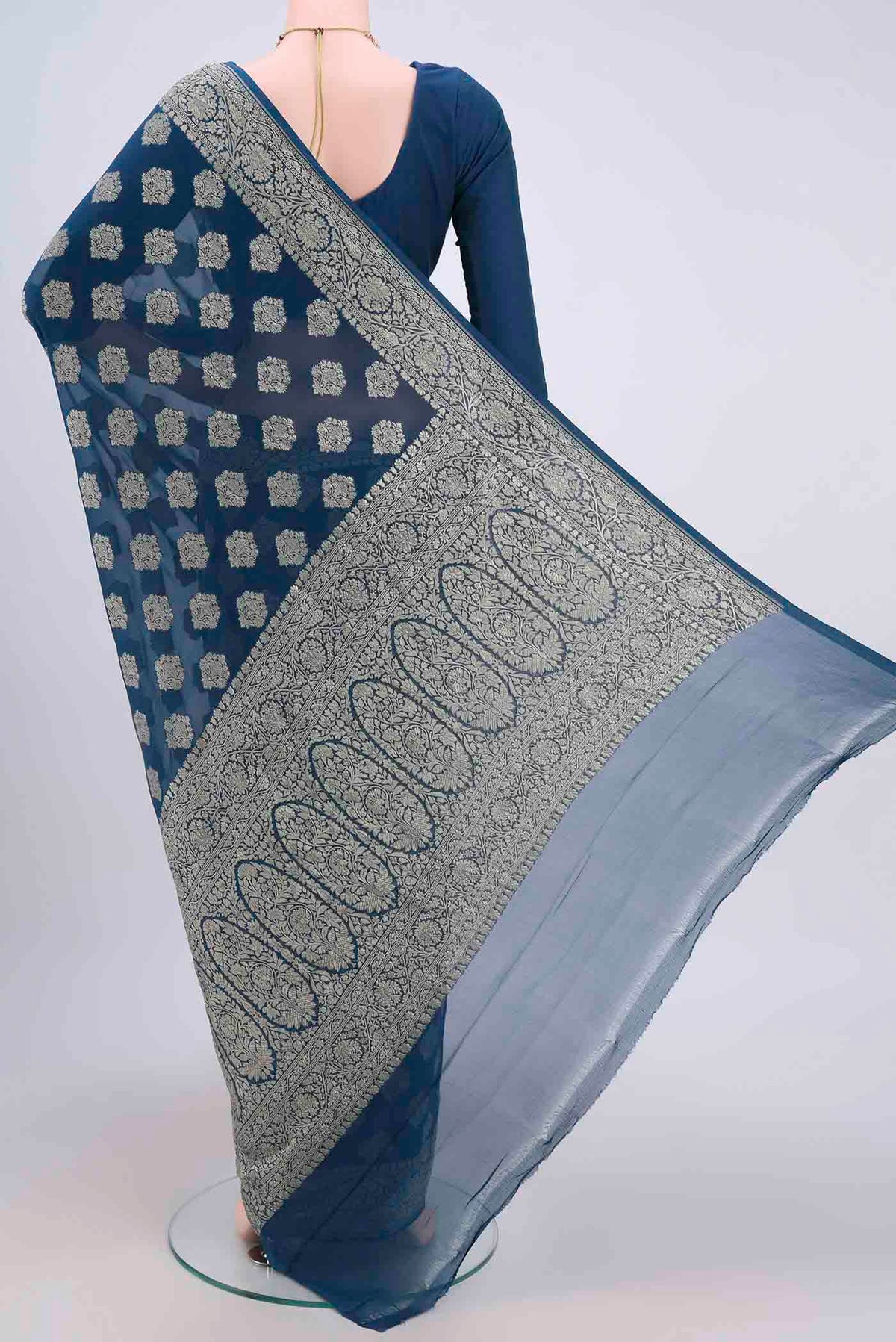 Flat view of Blue Banarasi Georgette Saree with Zari Brocade on the body and Zari Border. 