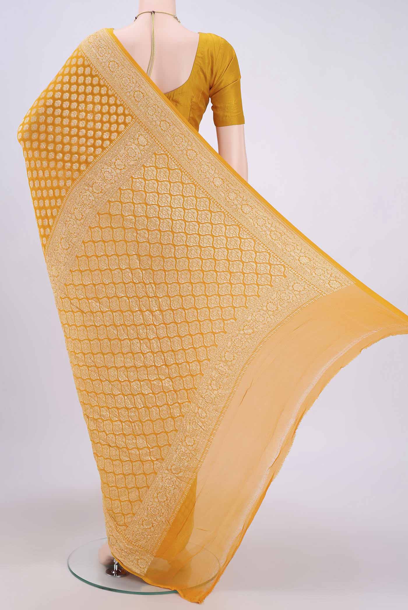 Flat view of Yellow Banarasi Georgette Saree with Zari Brocade on the body and Zari Border. 