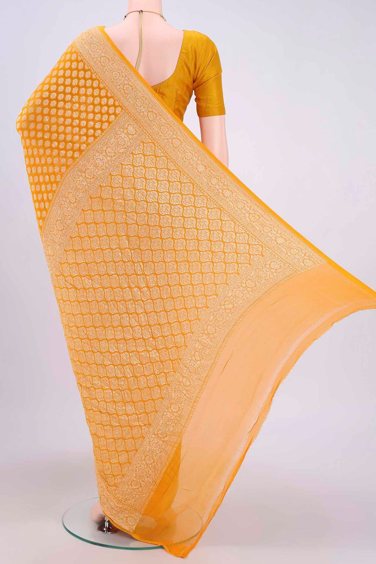 Flat view of Yellow Banarasi Georgette Saree with Zari Brocade on the body and Zari Border. 