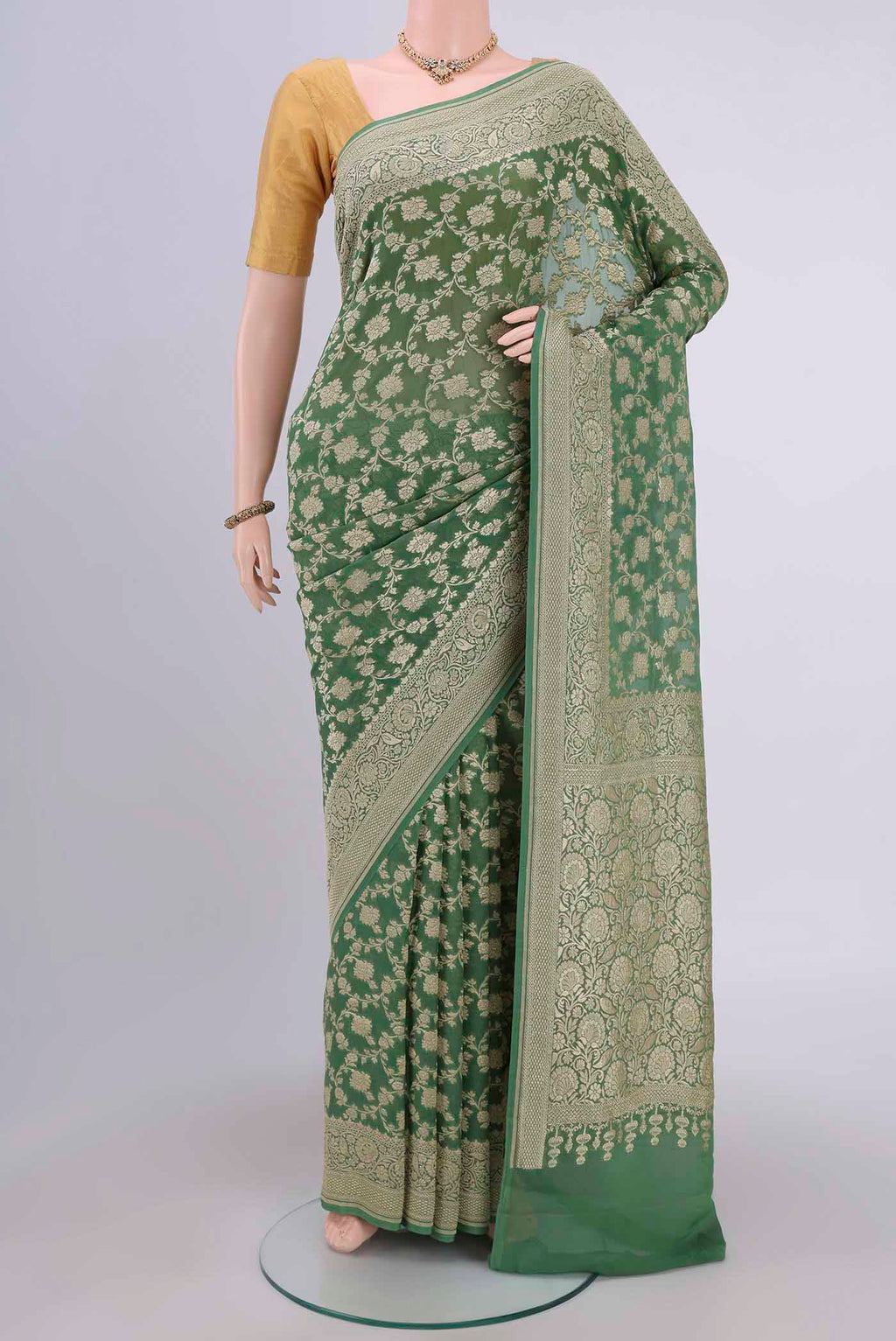 Light Green Banarasi Georgette Saree with Zari Brocade on the body and Zari Border.  displayed on a mannequin