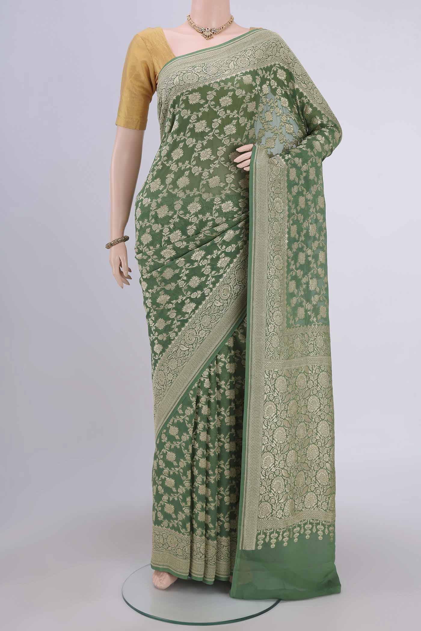 Light Green Banarasi Georgette Saree with Zari Brocade on the body and Zari Border.  displayed on a mannequin