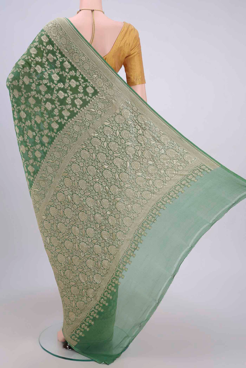 Flat view of Light Green Banarasi Georgette Saree with Zari Brocade on the body and Zari Border. 
