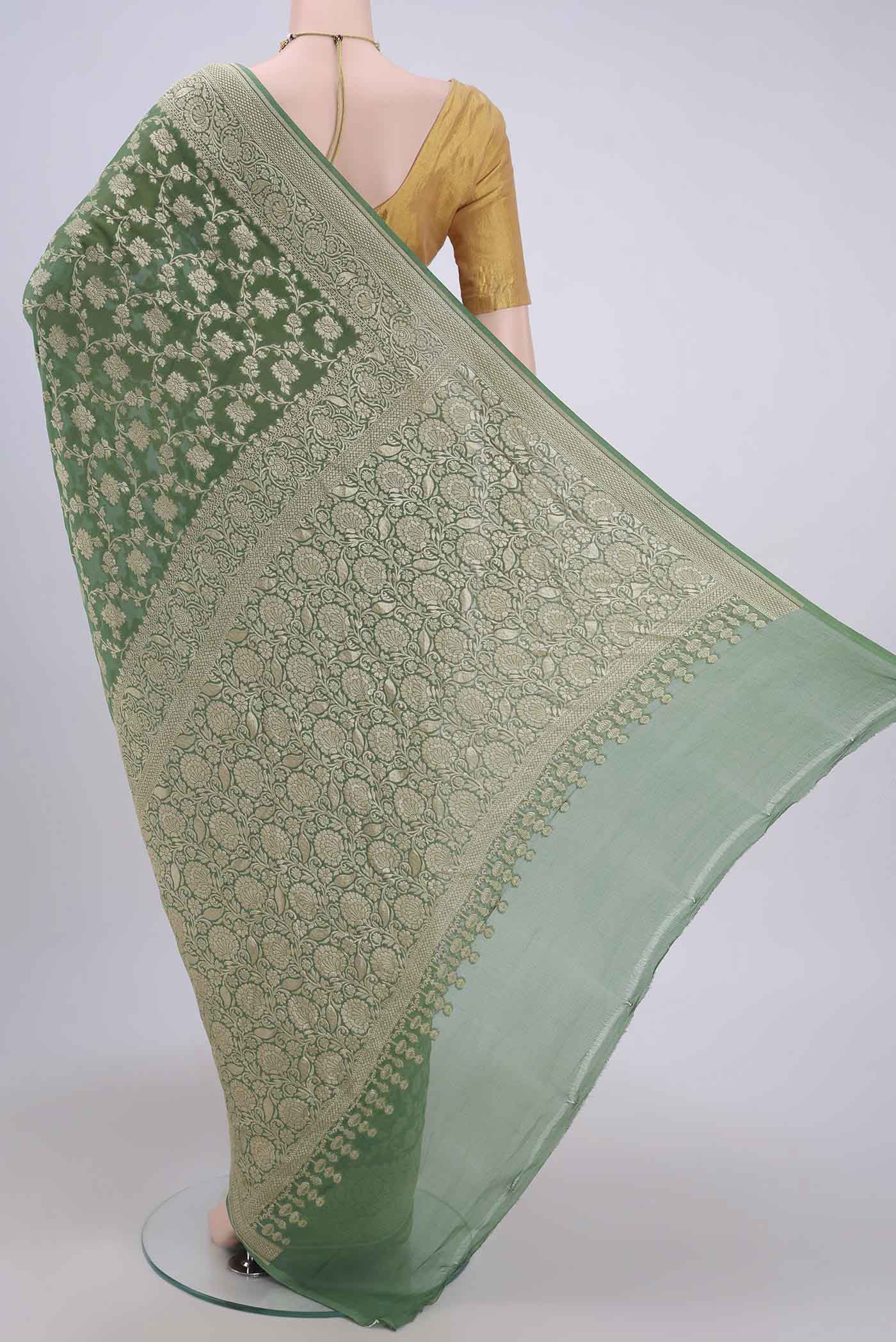 Flat view of Light Green Banarasi Georgette Saree with Zari Brocade on the body and Zari Border. 