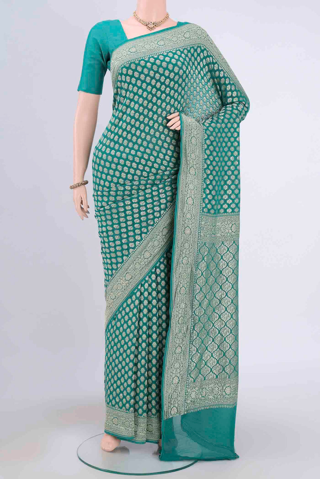 Sea Green Banarasi Georgette Saree with Zari Brocade on the body and Zari Border.  displayed on a mannequin