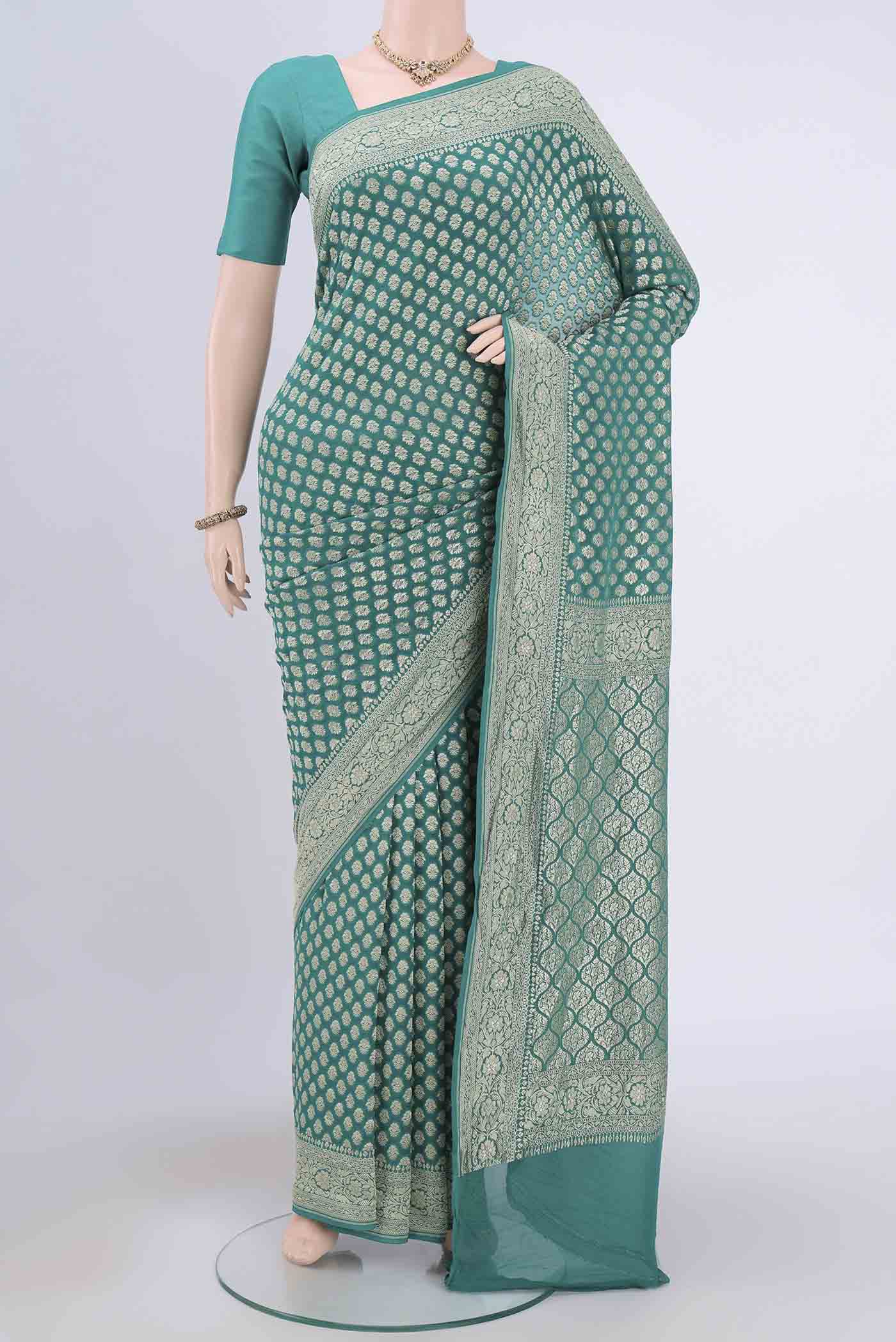Sea Green Banarasi Georgette Saree with Zari Brocade on the body and Zari Border.  displayed on a mannequin