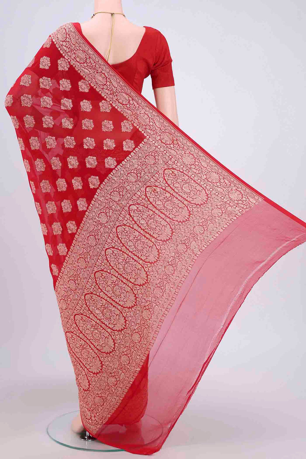 Flat view of Red Banarasi Georgette Saree with Zari Brocade on the body and Zari Border. 