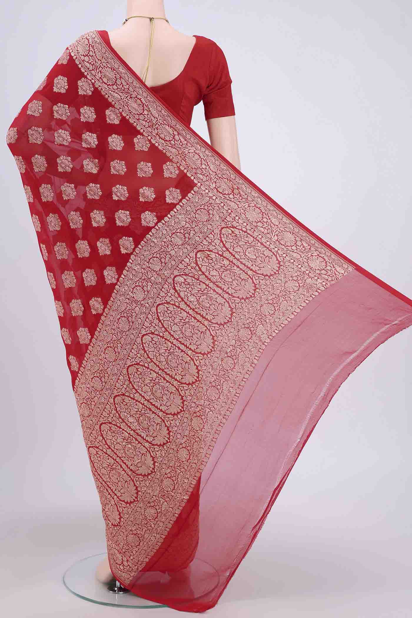 Flat view of Red Banarasi Georgette Saree with Zari Brocade on the body and Zari Border. 