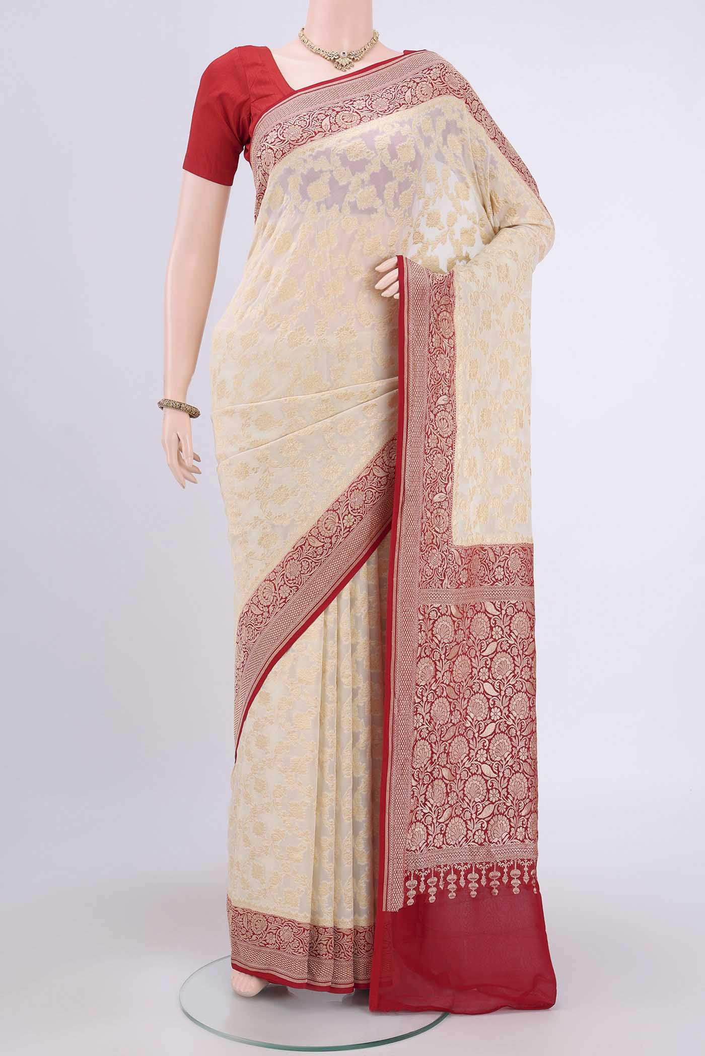 Cream Banarasi Georgette Saree with Zari Brocade on the body and Zari Border.  displayed on a mannequin