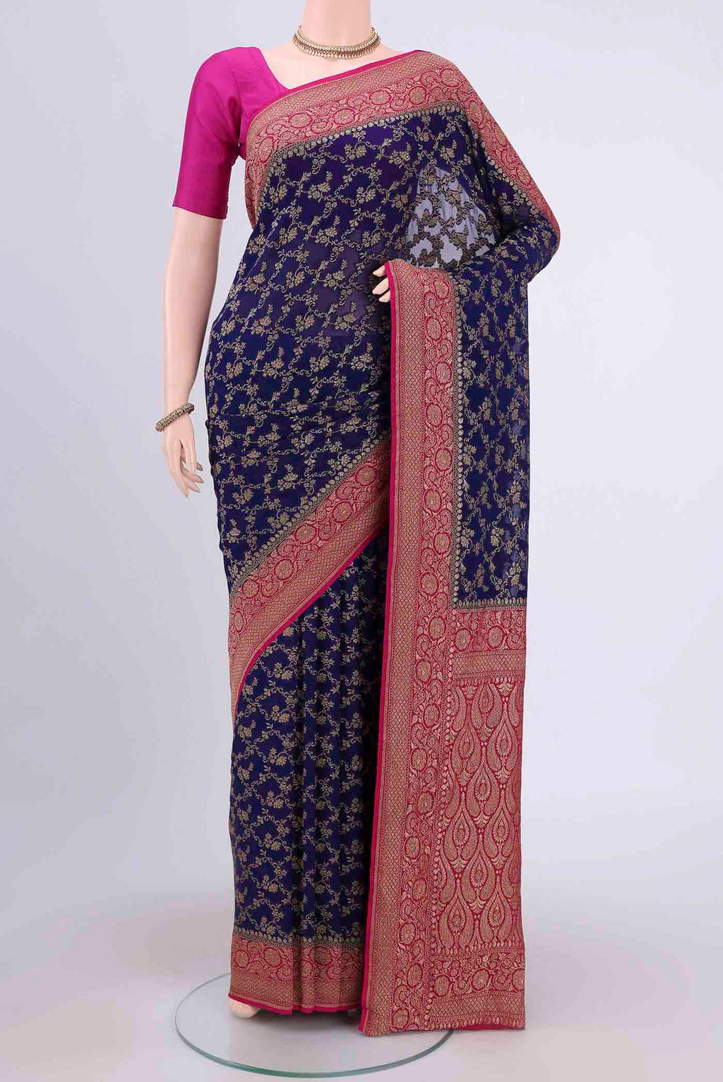 Navy Blue Banarasi Georgette Saree with Zari Brocade on the body and Zari Border.  displayed on a mannequin