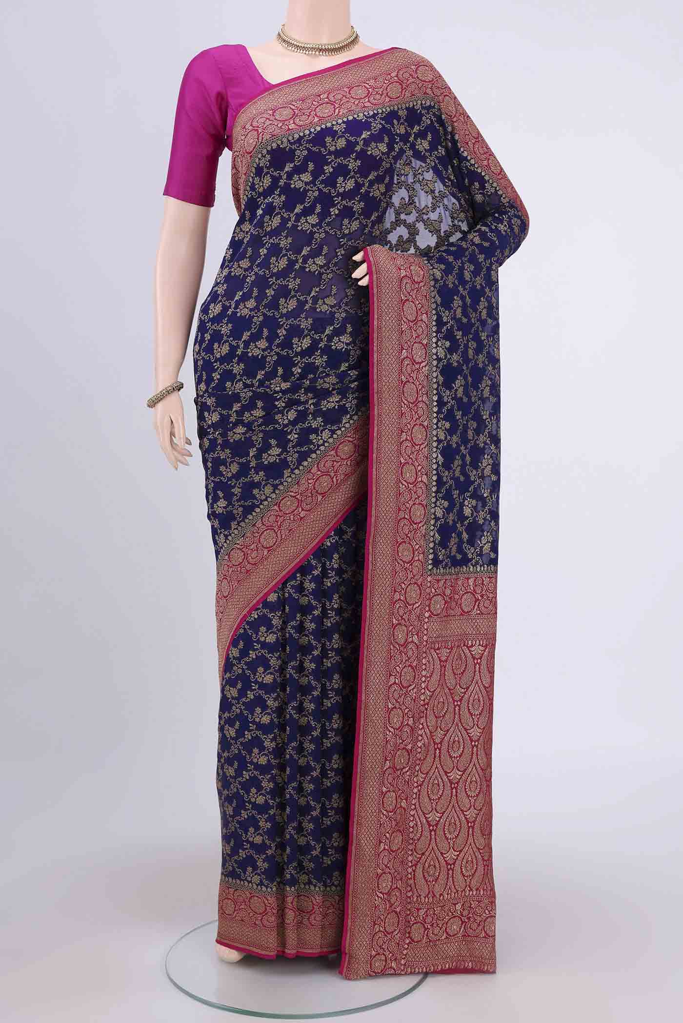 Navy Blue Banarasi Georgette Saree with Zari Brocade on the body and Zari Border.  displayed on a mannequin