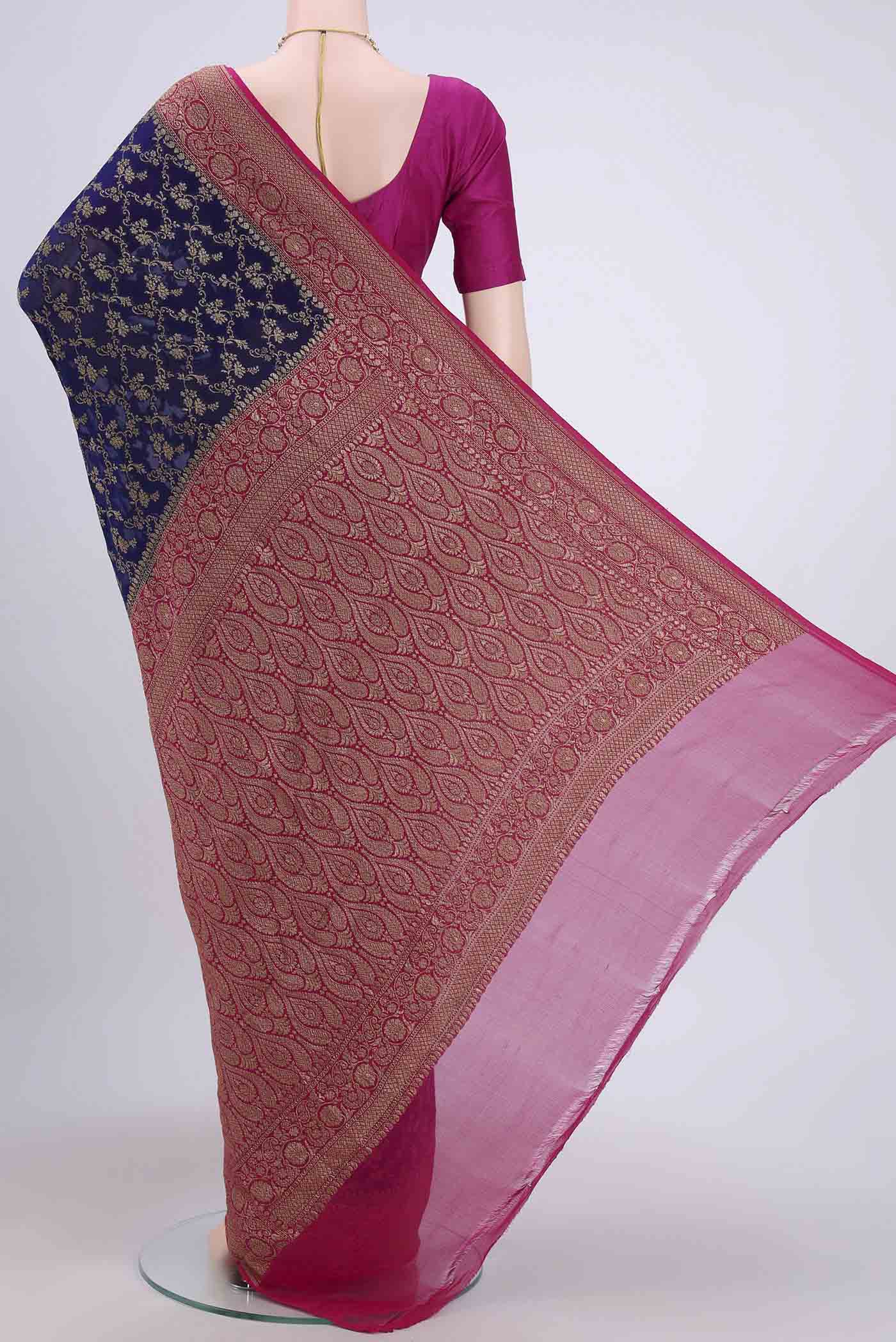 Flat view of Navy Blue Banarasi Georgette Saree with Zari Brocade on the body and Zari Border. 