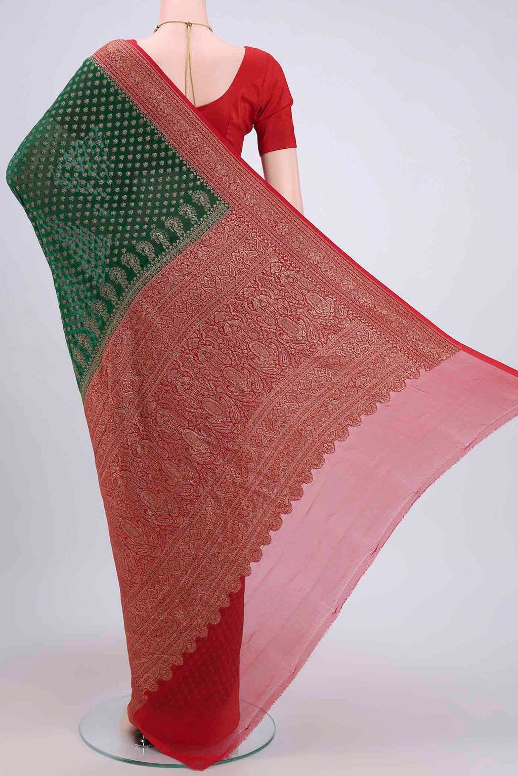Flat view of Bottle Green Banarasi Georgette Saree with Zari Brocade on the body and Zari Border. 