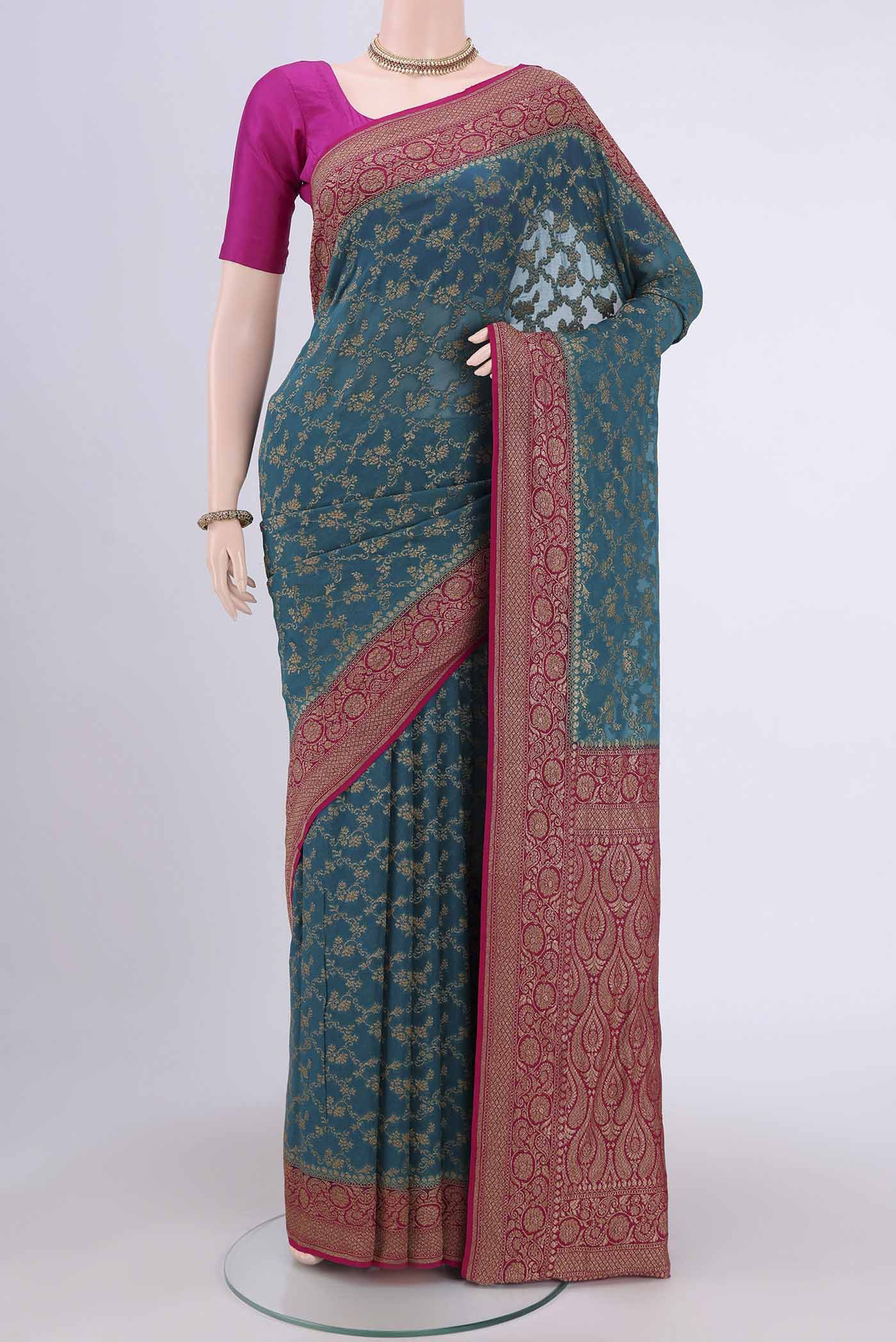 Sea Green Banarasi Georgette Saree with Zari Brocade on the body and Zari Border.  displayed on a mannequin