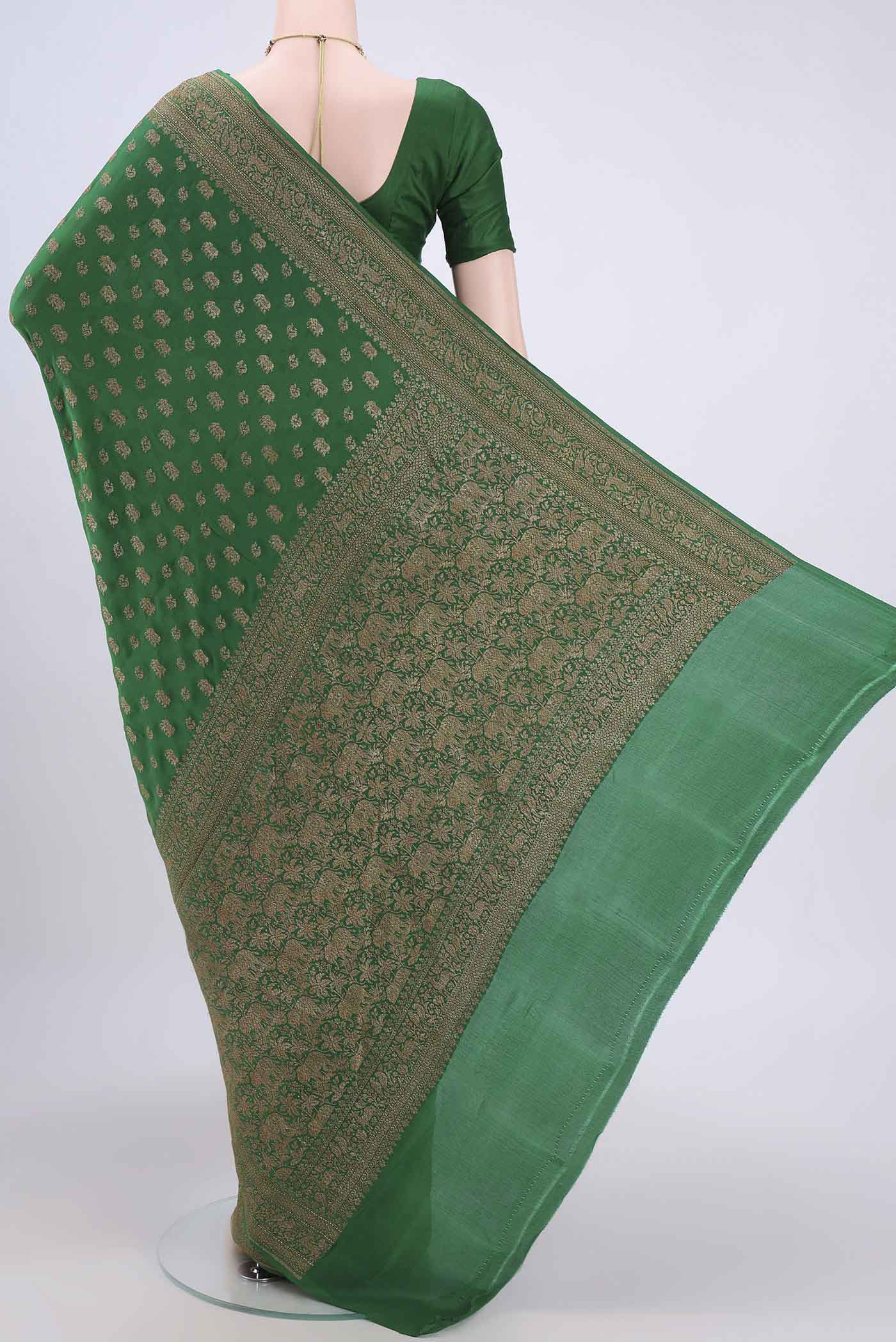 Flat view of Bottle Green Banarasi Georgette Saree with Zari Brocade on the body and Zari Border. 