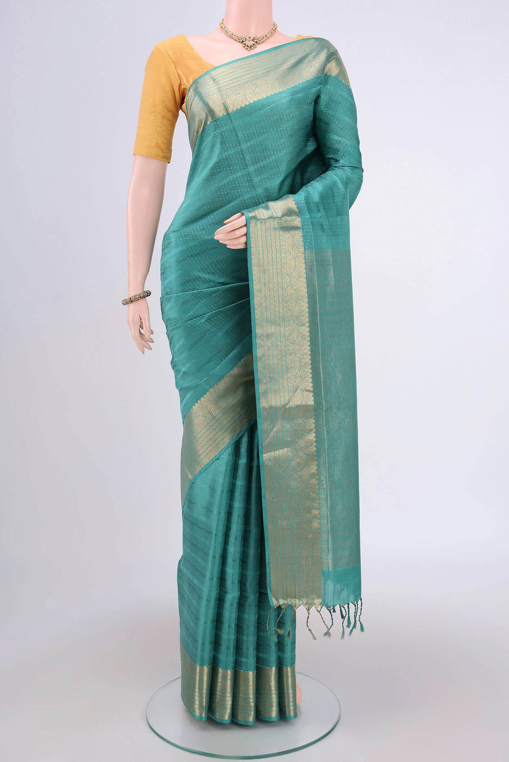 Sage Green Soft Silk Saree with Jacquard With Zari Butta on the body and Zari Border.  displayed on a mannequin