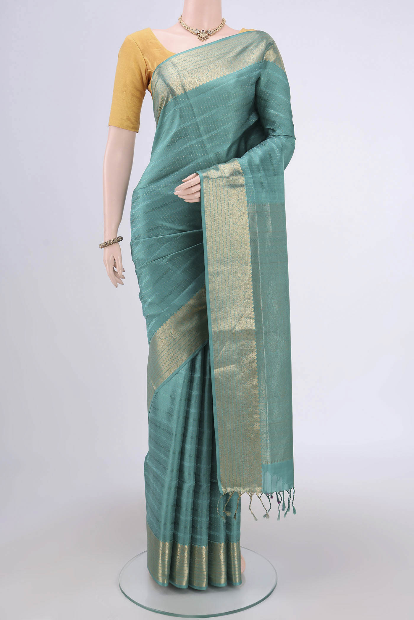 Sage Green Soft Silk Saree with Jacquard With Zari Butta on the body and Zari Border.  displayed on a mannequin