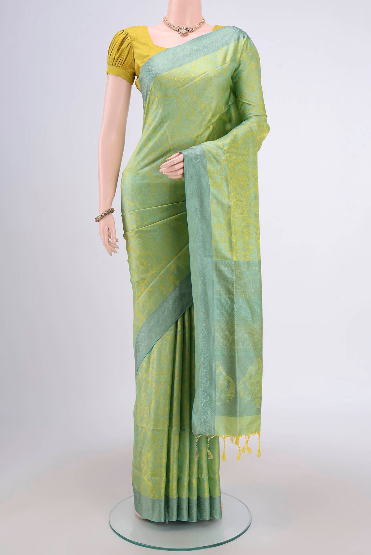 Acid Green Soft Silk Saree with Jacquard design on the body and Thread Border.  displayed on a mannequin