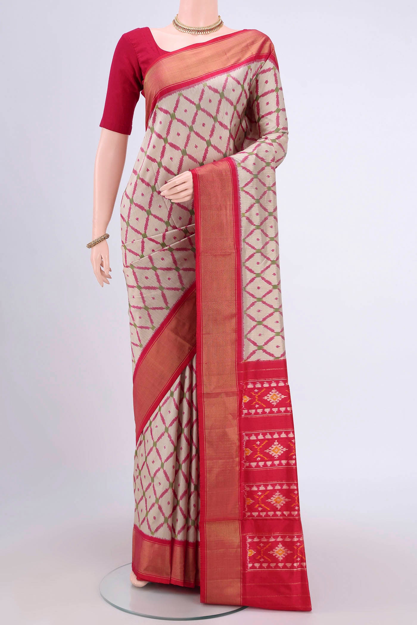 Beige Pochampally Silk Saree with Pure Ikat on the body and Zari Border.  displayed on a mannequin