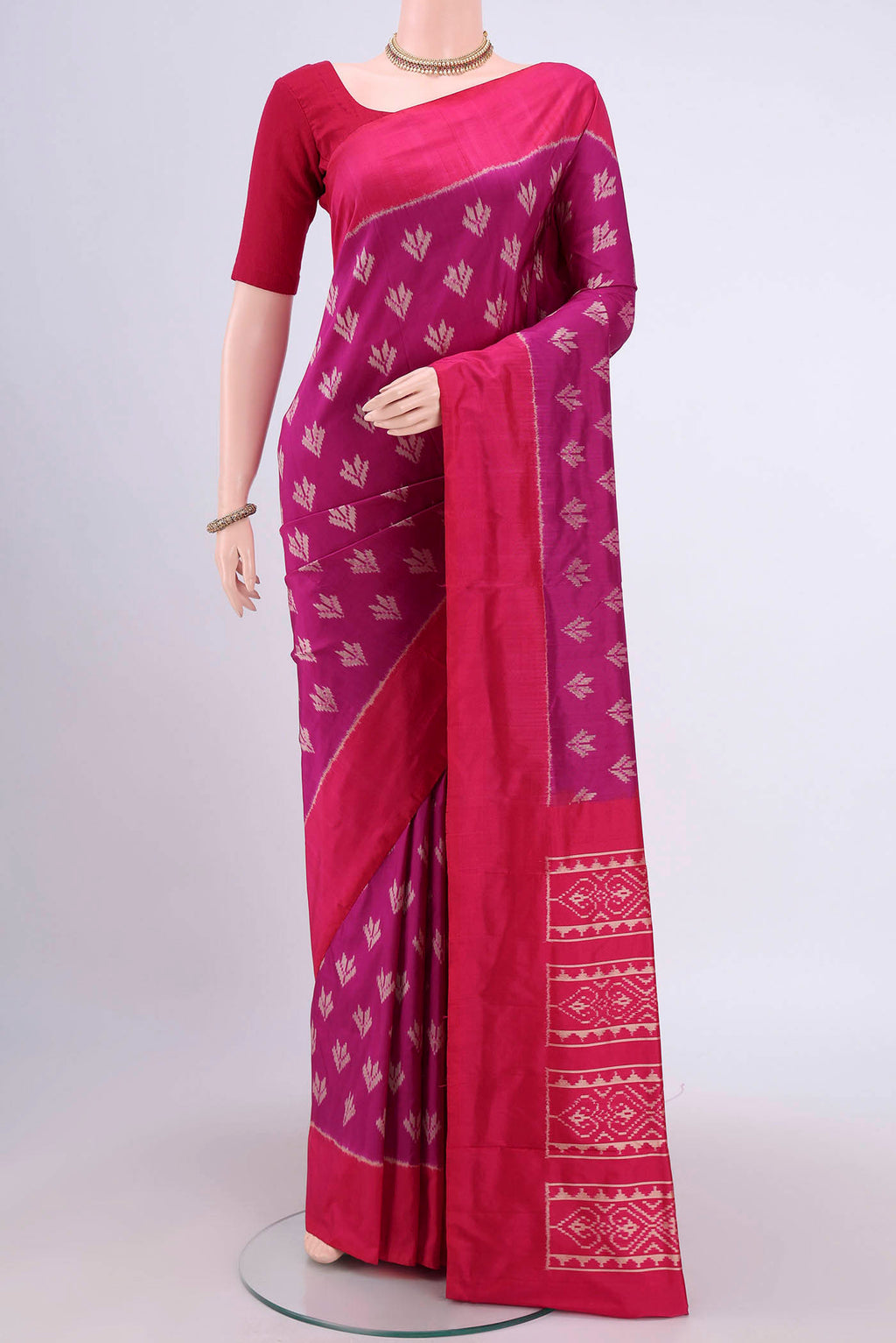 Magenta Pochampally Silk Saree with Pure Ikat on the body and Plain Border.  displayed on a mannequin