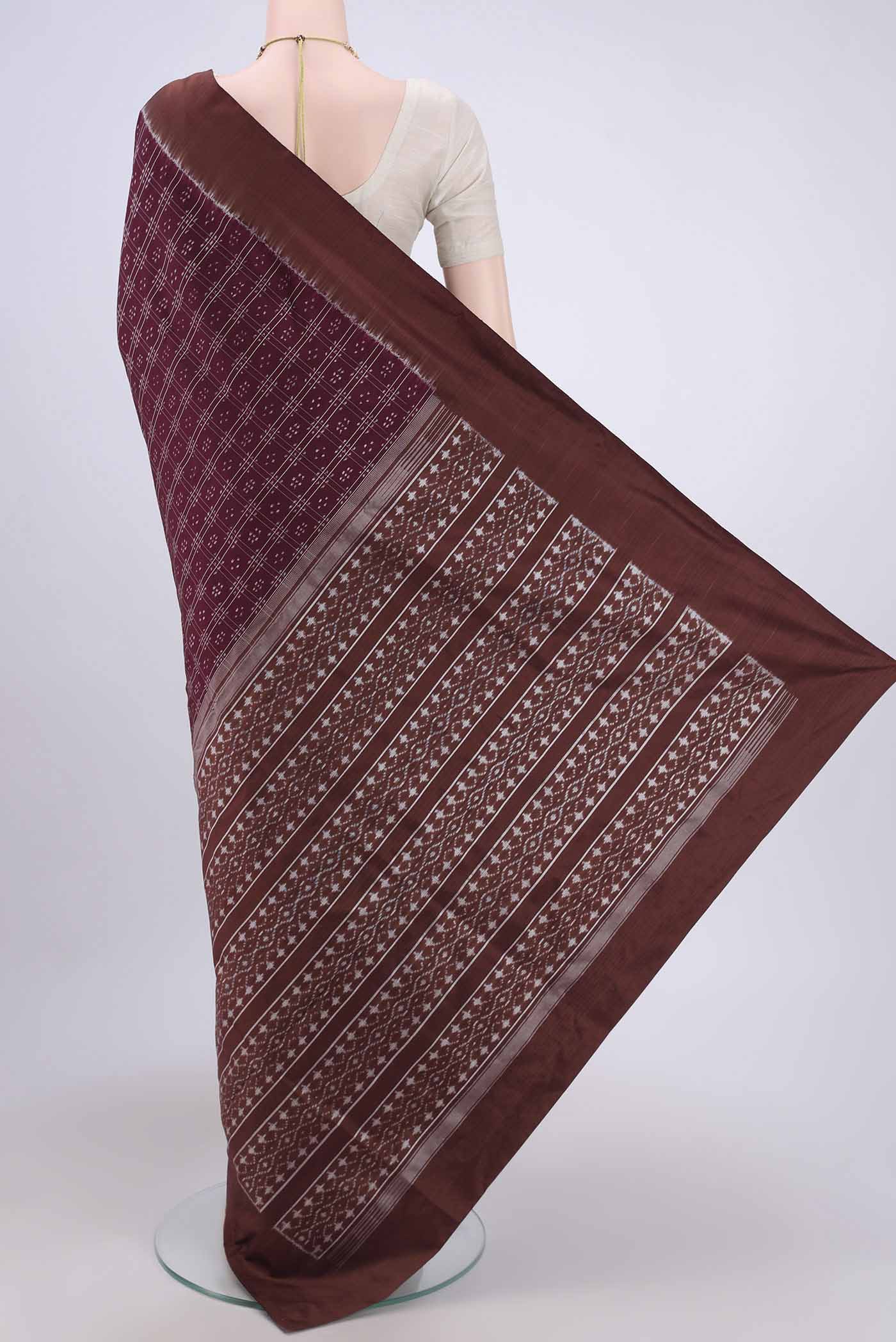 Flat view of Burgundy Pochampally Silk Saree with Checked design on the body and Plain Border. 