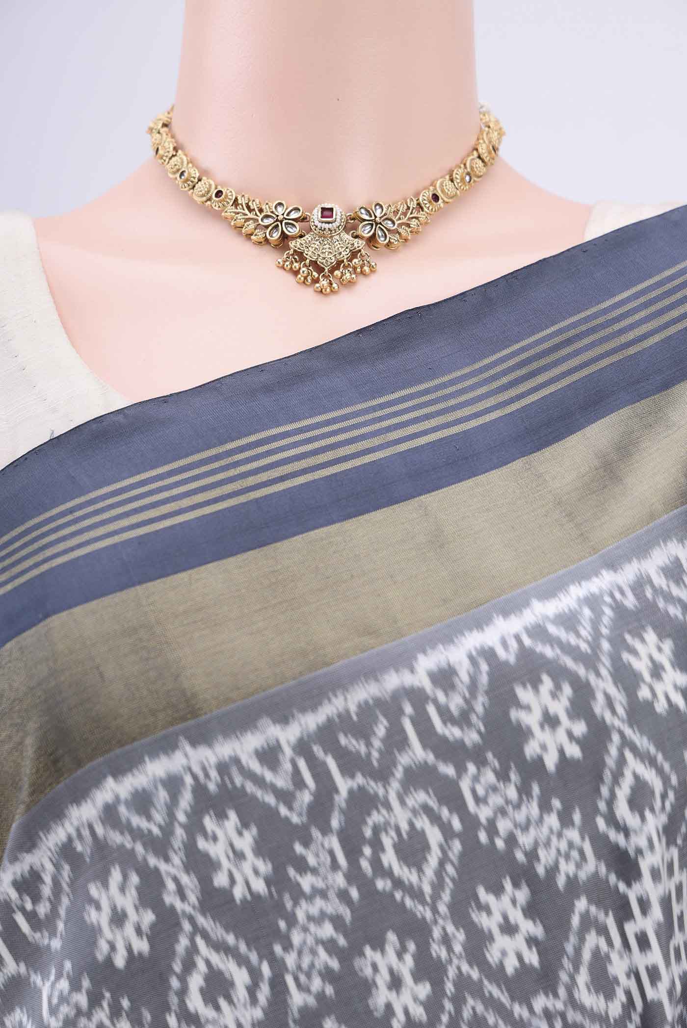 Border image of Grey Pochampally Silk Saree with Pure Ikat on the body and Zari Border. 