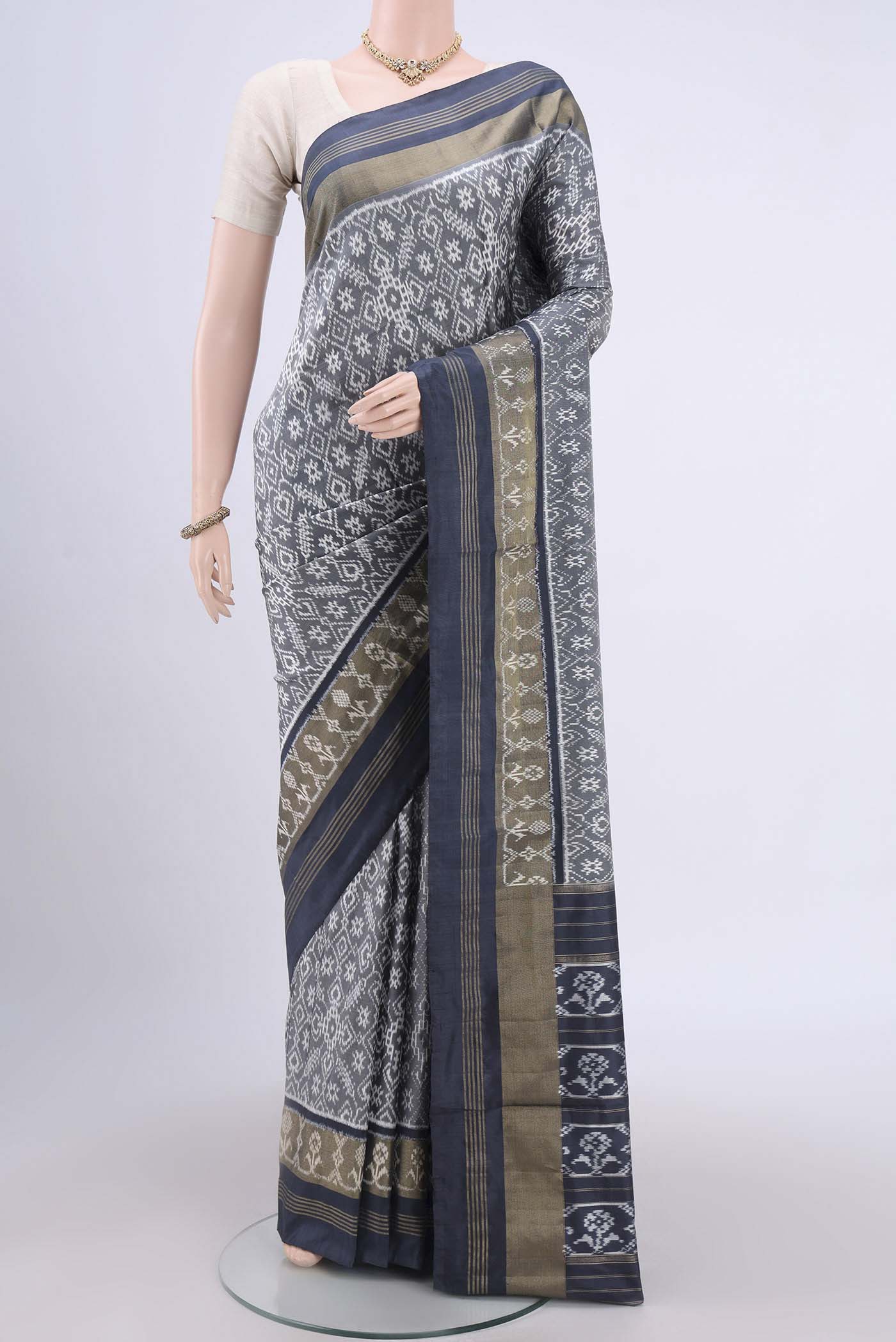 Grey Pochampally Silk Saree with Pure Ikat on the body and Zari Border.  displayed on a mannequin