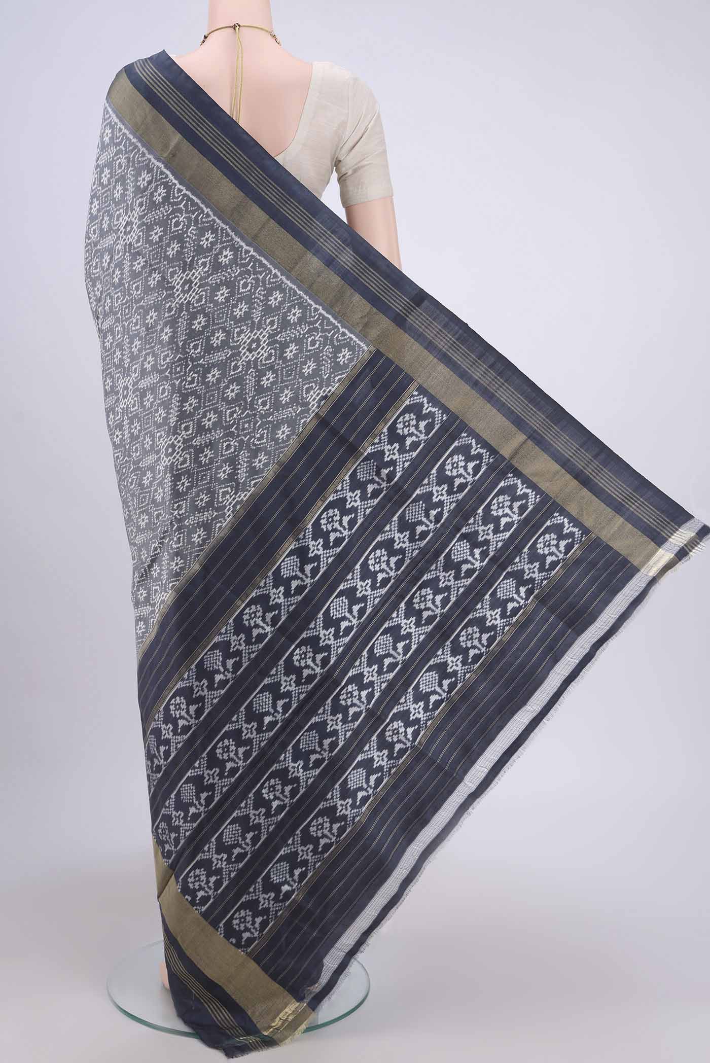 Flat view of Grey Pochampally Silk Saree with Pure Ikat on the body and Zari Border. 