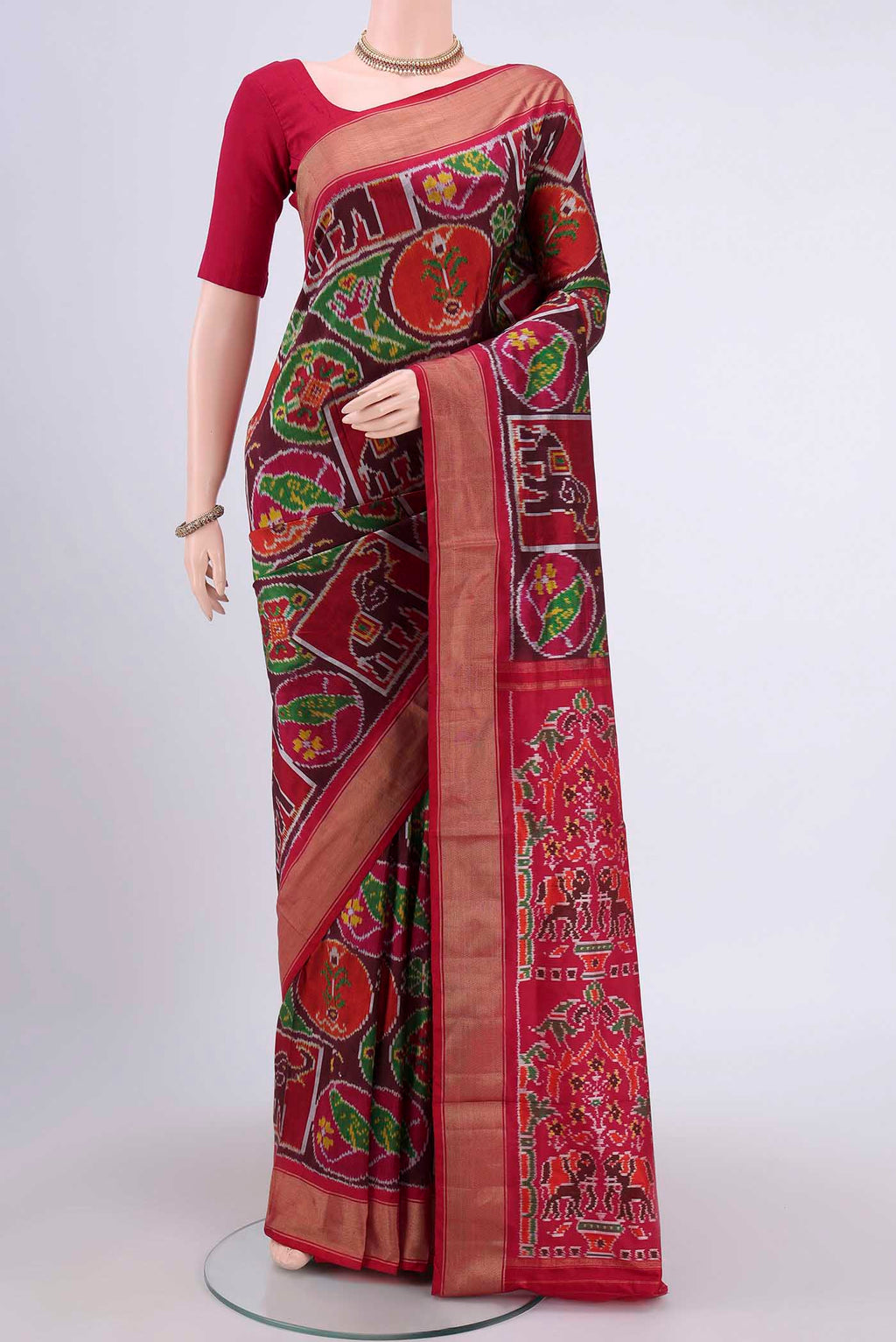 Brown Pochampally Silk Saree with Pure Ikat on the body and Zari Border.  displayed on a mannequin