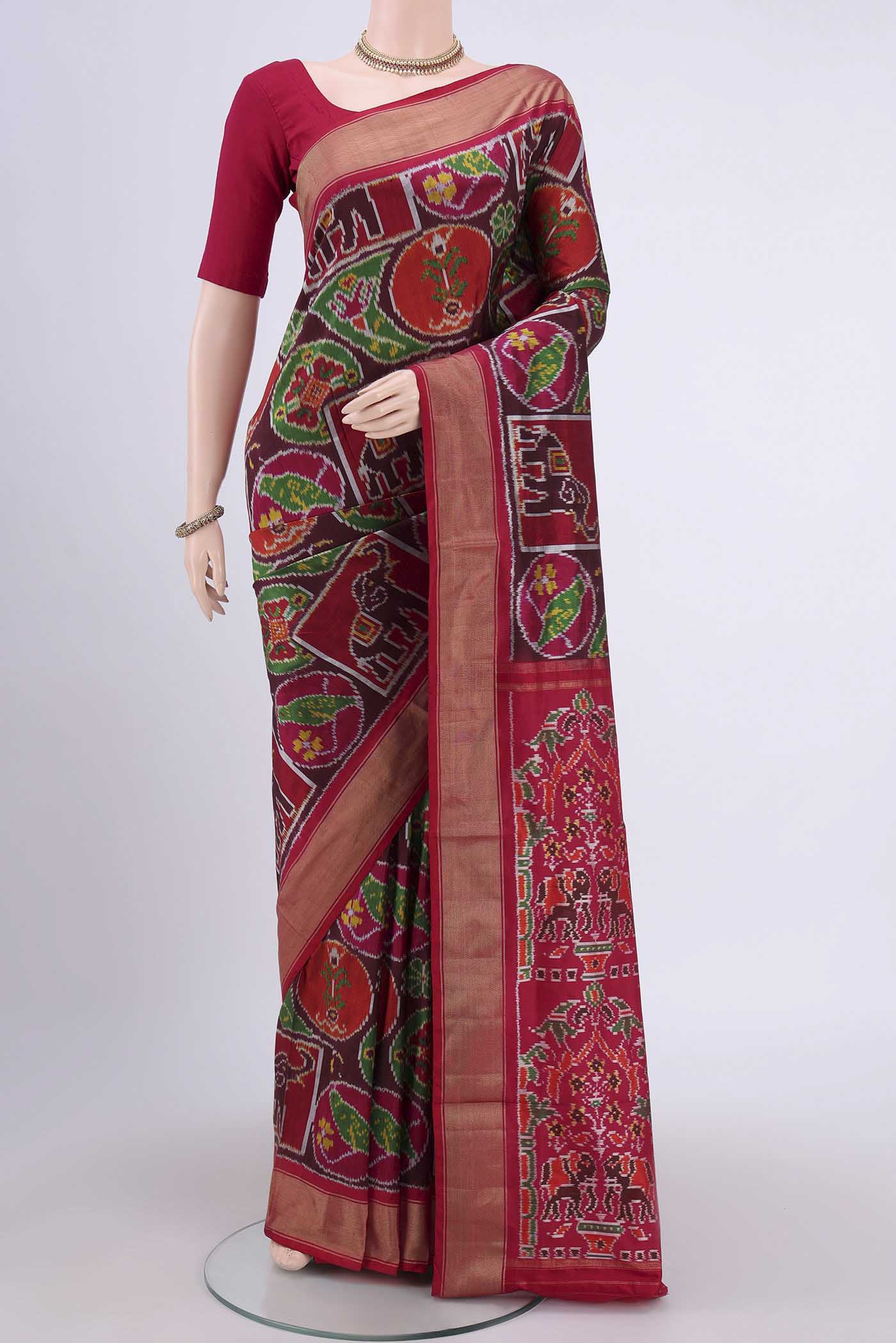 Brown Pochampally Silk Saree with Pure Ikat on the body and Zari Border.  displayed on a mannequin