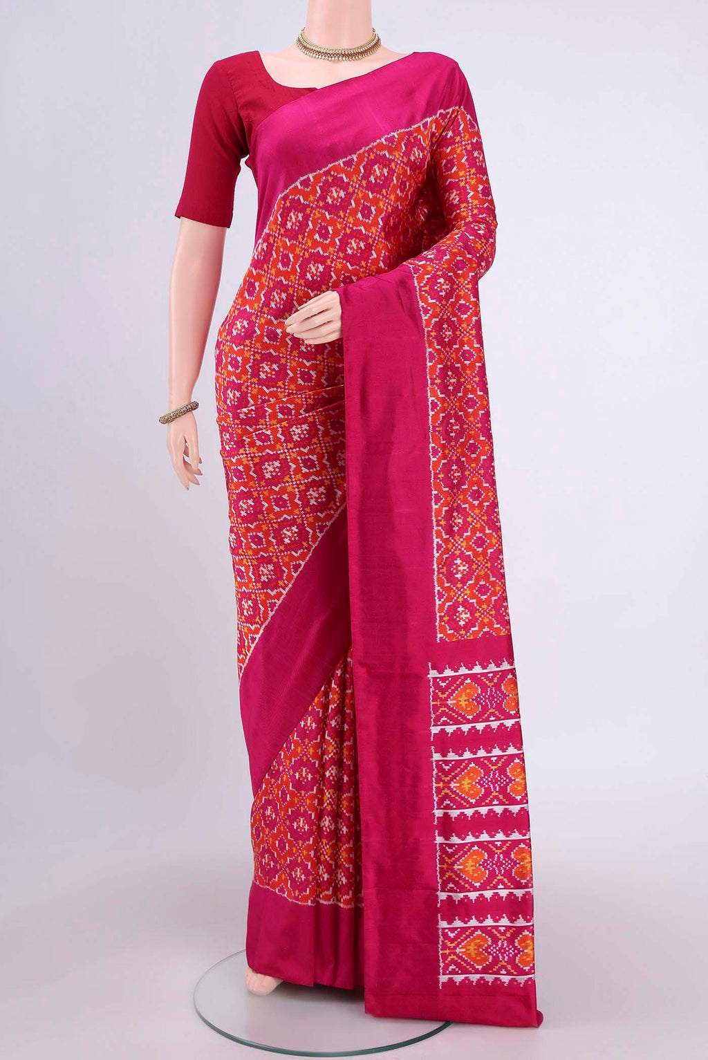 Rust Pochampally Silk Saree with Pure Ikat on the body and Plain Border.  displayed on a mannequin