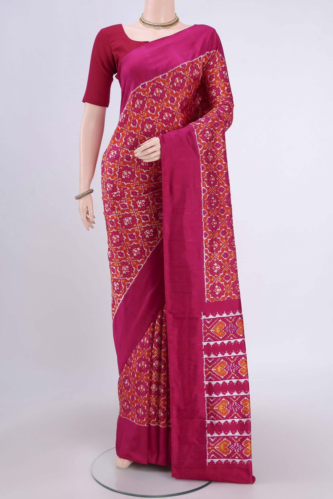 Rust Pochampally Silk Saree with Pure Ikat on the body and Plain Border.  displayed on a mannequin