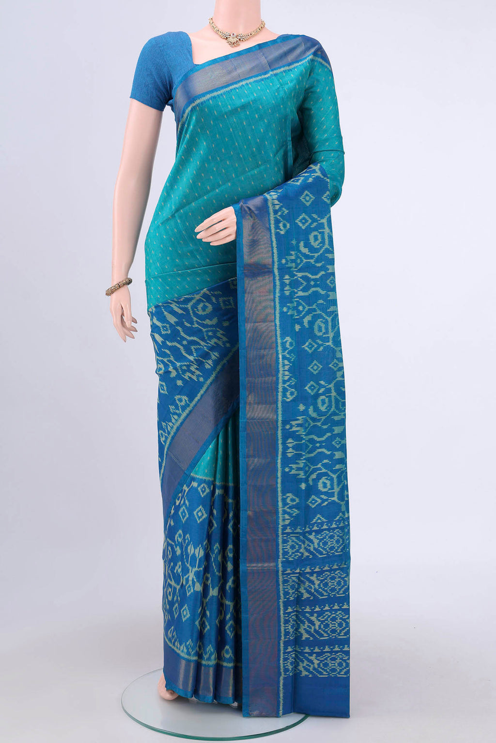 Sea Green Rajkot Patola Silk Saree with Pure Ikat on the body and Zari Border.  displayed on a mannequin