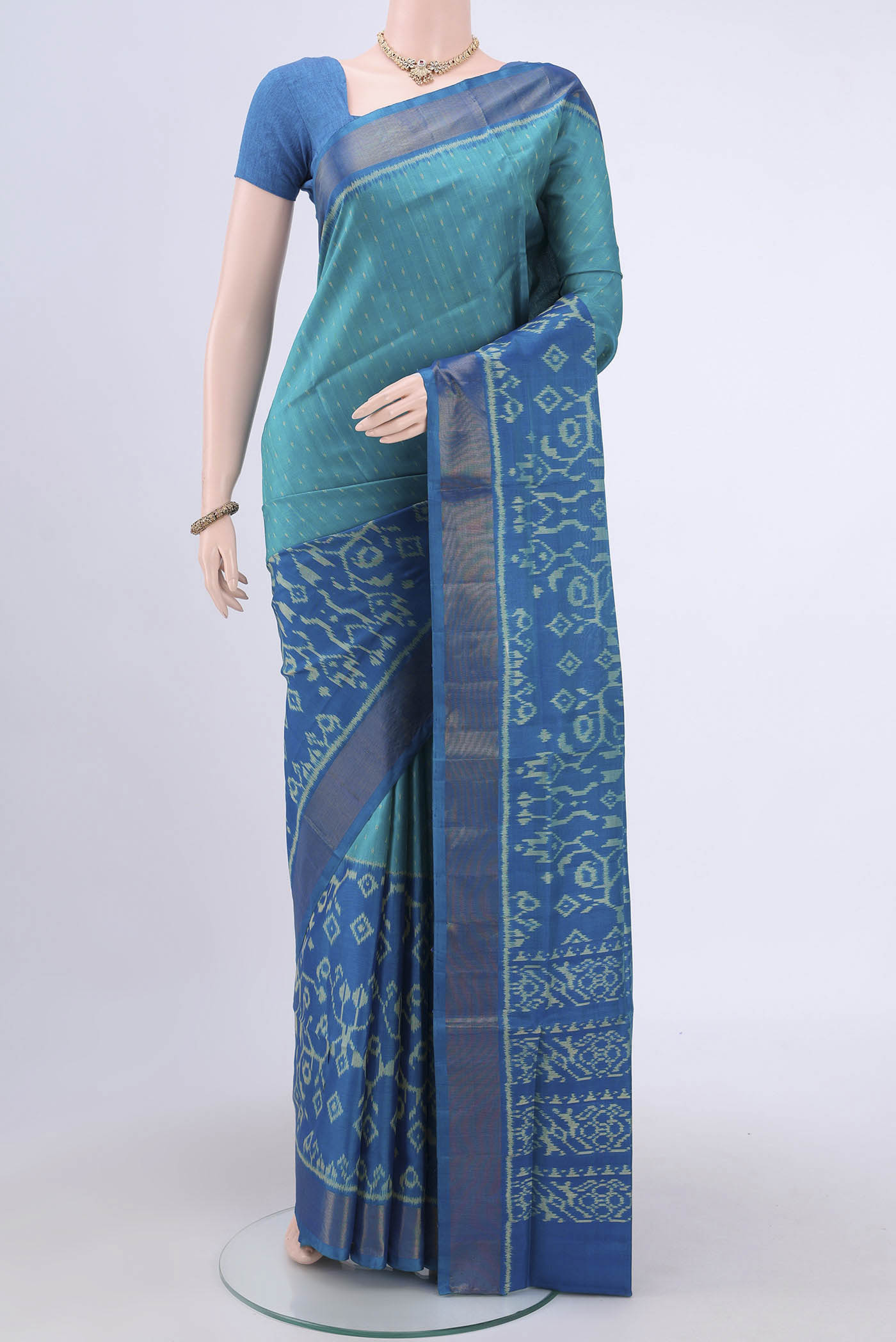 Sea Green Rajkot Patola Silk Saree with Pure Ikat on the body and Zari Border.  displayed on a mannequin