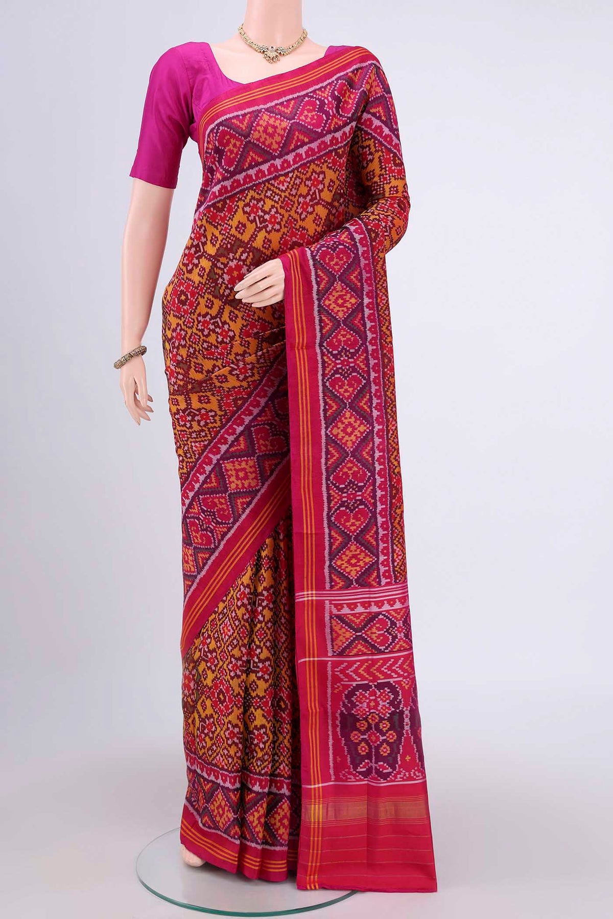 Multi Color Rajkot Patola Silk Saree with Pure Ikat on the body and Zari Border.  displayed on a mannequin