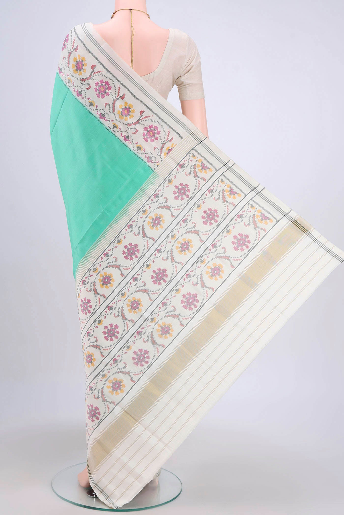 Flat view of Mint Green Rajkot Patola Silk Saree with Pure Ikat on the body and Plain Border. 