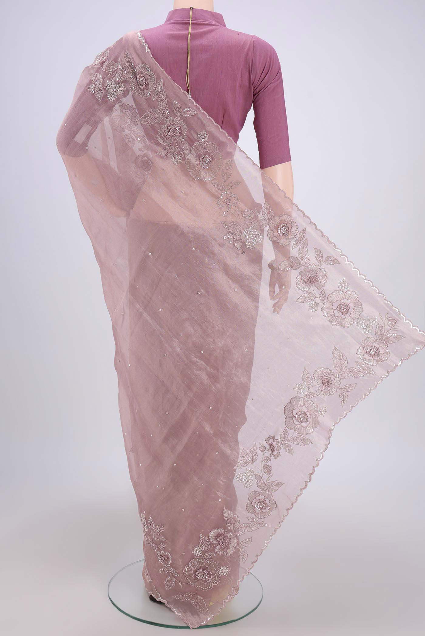 Flat view of Rose Gold Organza Silk Saree with Embroidery on the body and Zari Border. 