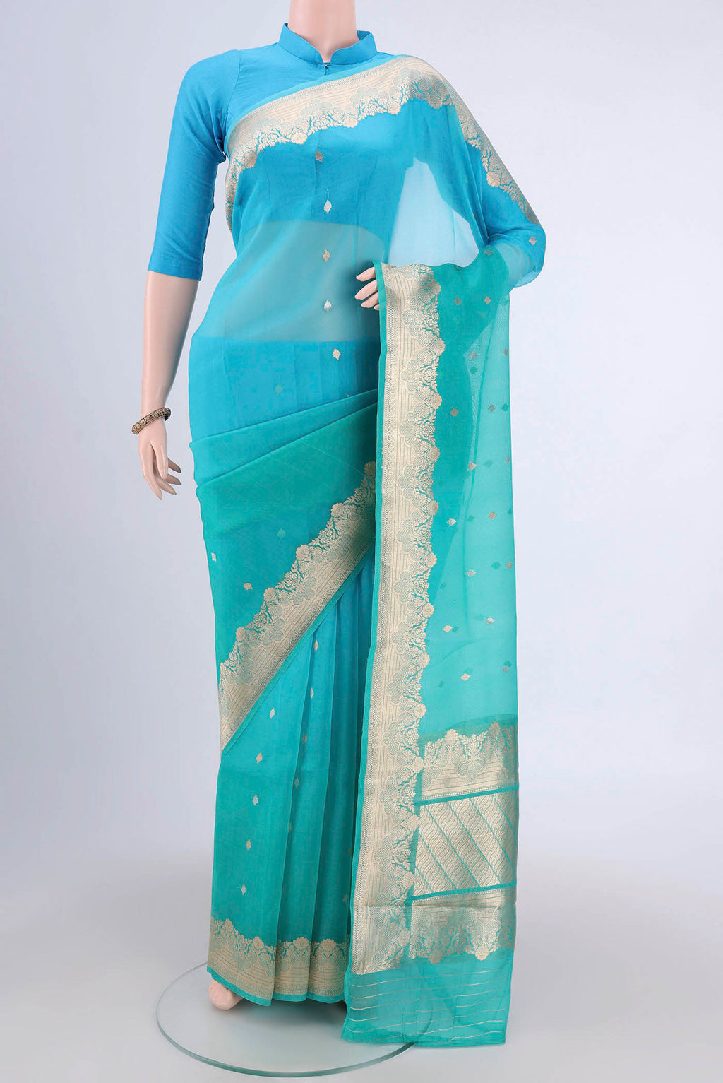 Sea Green Organza Silk Saree with Half And Half on the body and Zari Border.  displayed on a mannequin