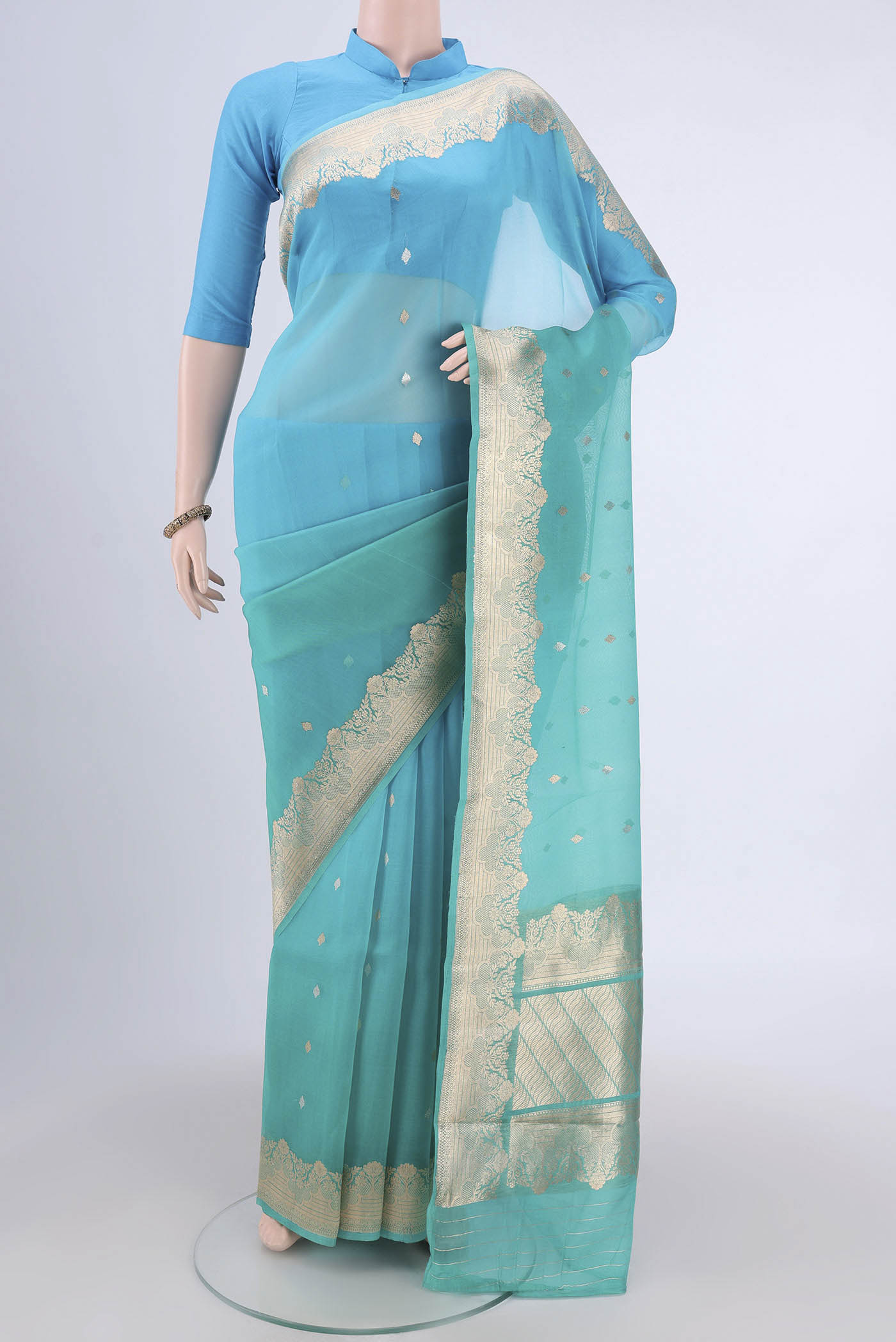 Sea Green Organza Silk Saree with Half And Half on the body and Zari Border.  displayed on a mannequin