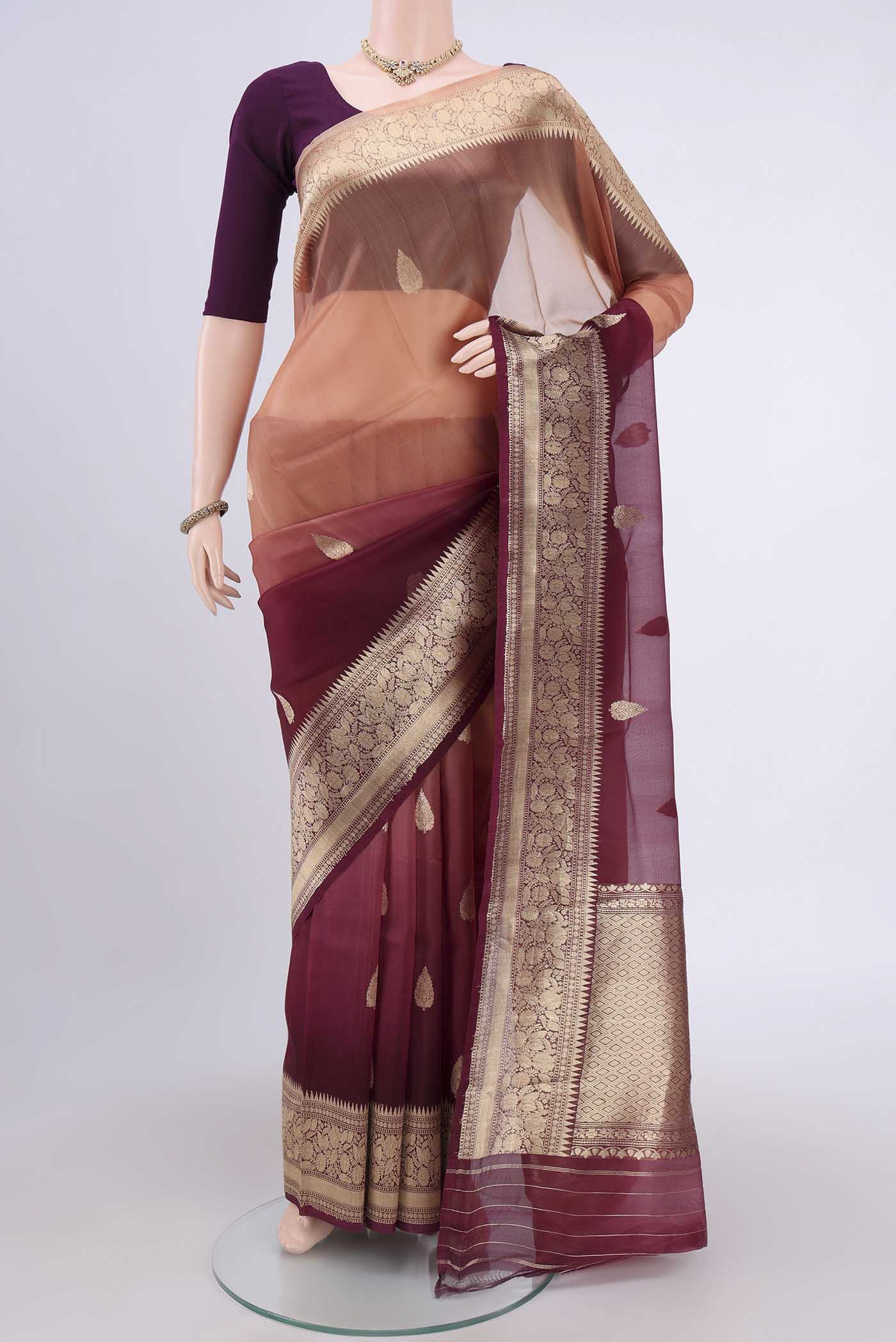 Burgundy Organza Silk Saree with Half And Half on the body and Zari Border.  displayed on a mannequin